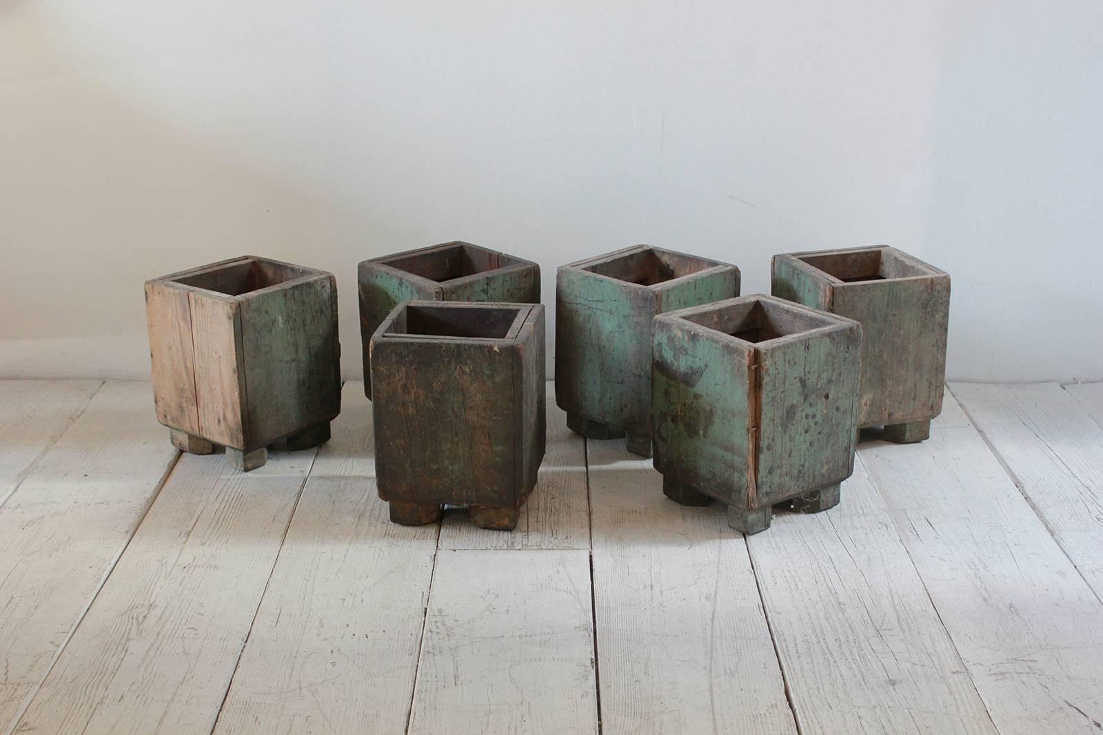 Square rustic wood planters with aged patina.