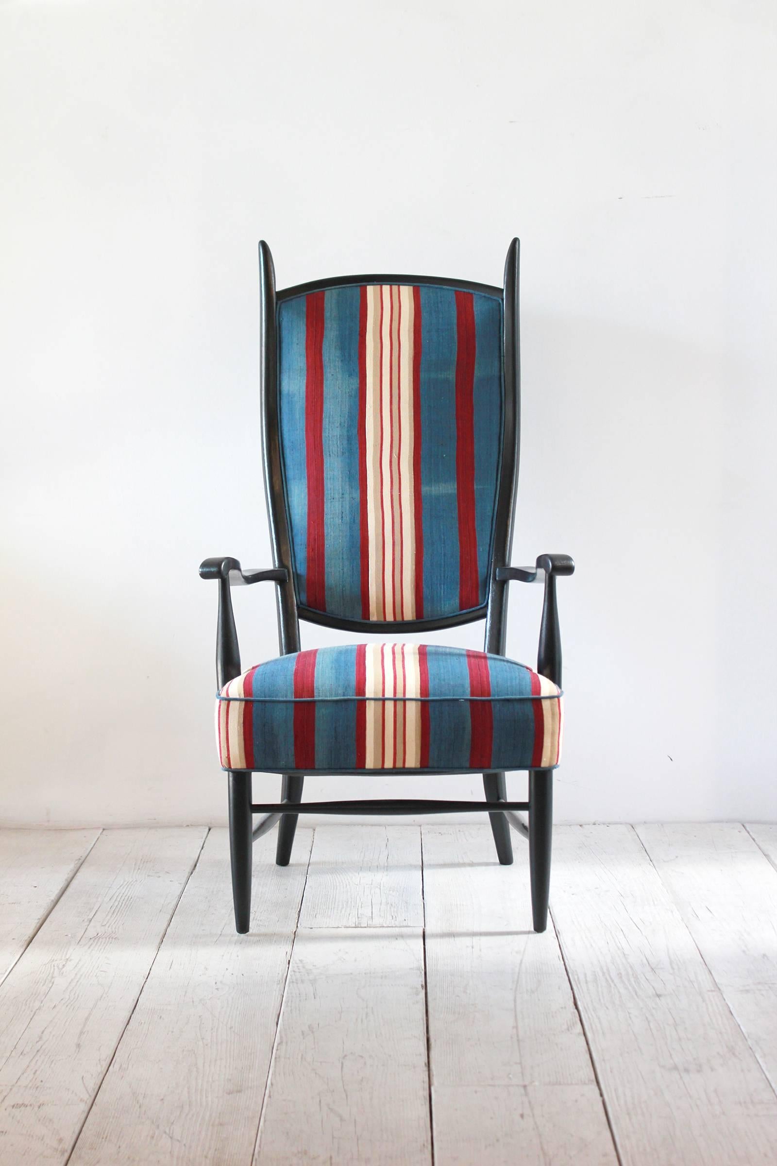 Black painted Spanish high back chair upholstered in vintage striped African fabric.