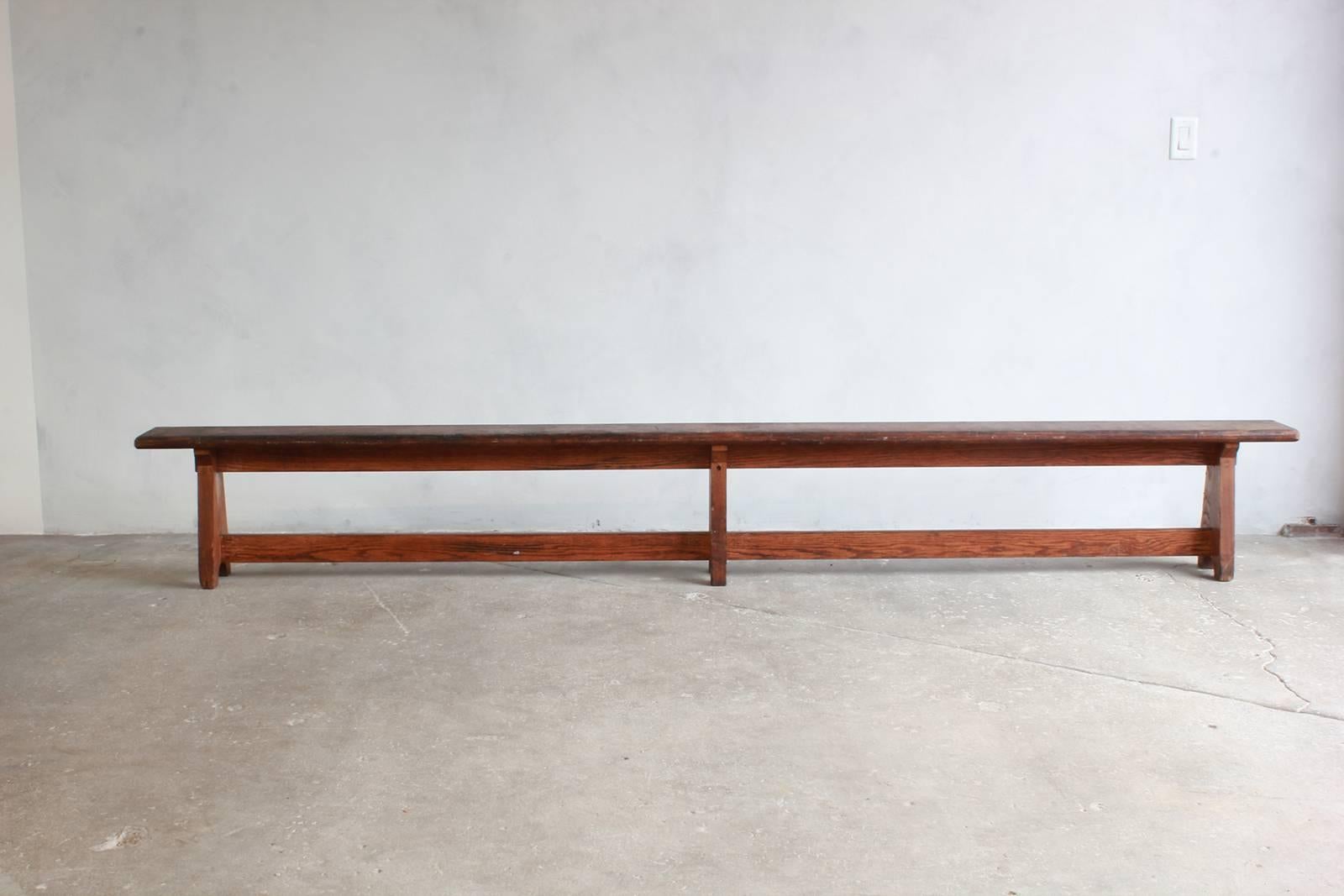 Long rustic bench with middle leg.