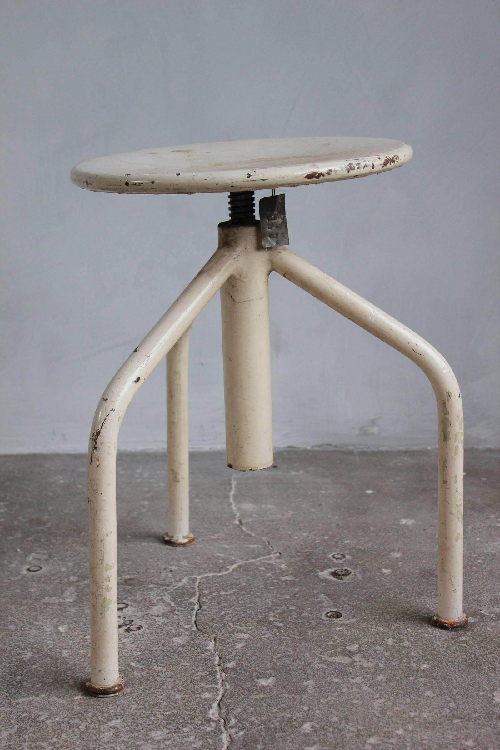 White painted wood and metal three legged swivel stools.