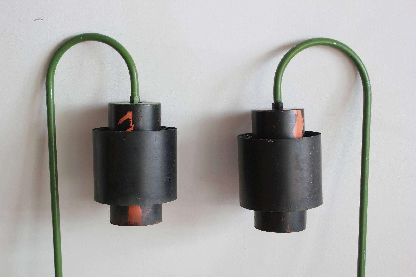 Pair of over arching green and black painted metal outdoor lanterns.