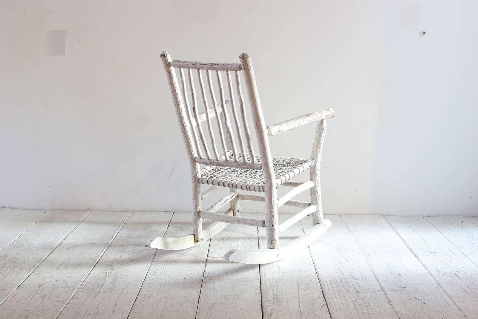 Wood painted rocking chair with rope seat.