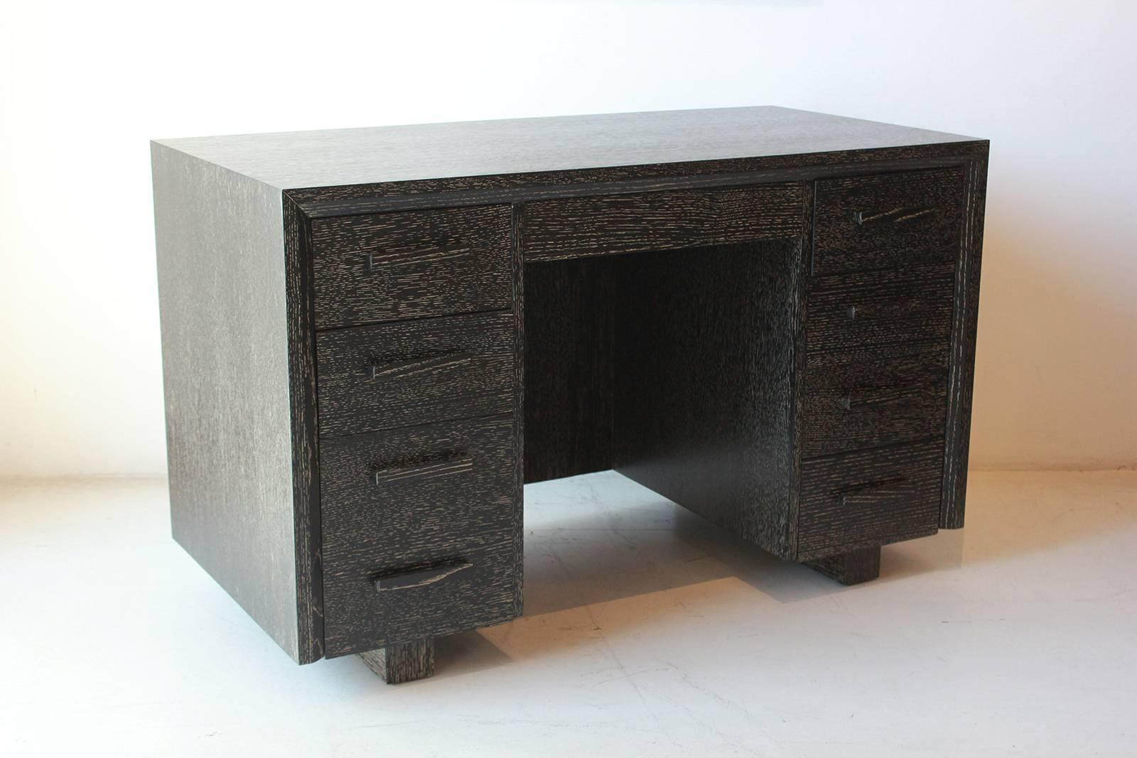 Black cerused nine-drawer desk.