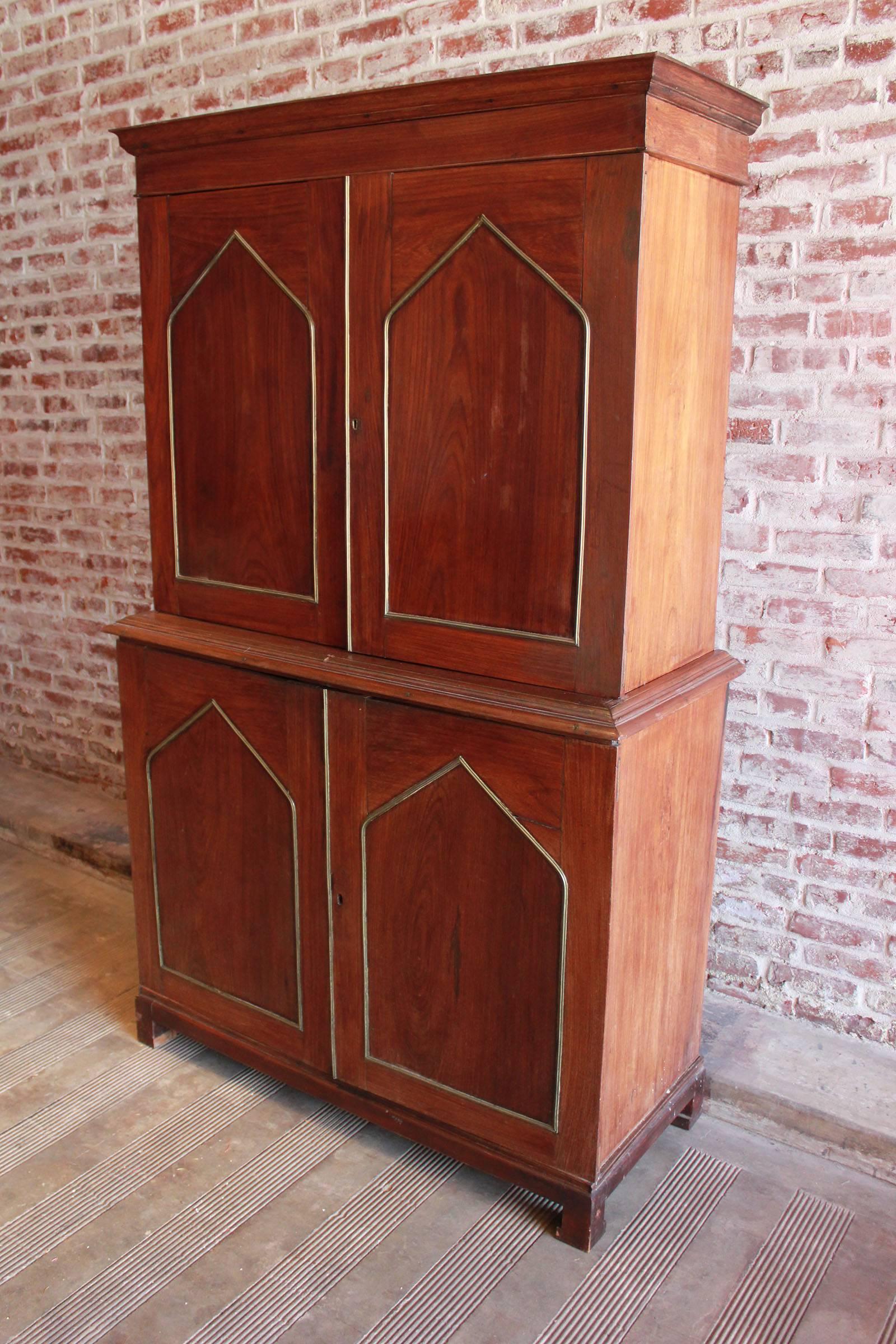 Mahogany neo-Gothic linen press cabinet with brass inlay.