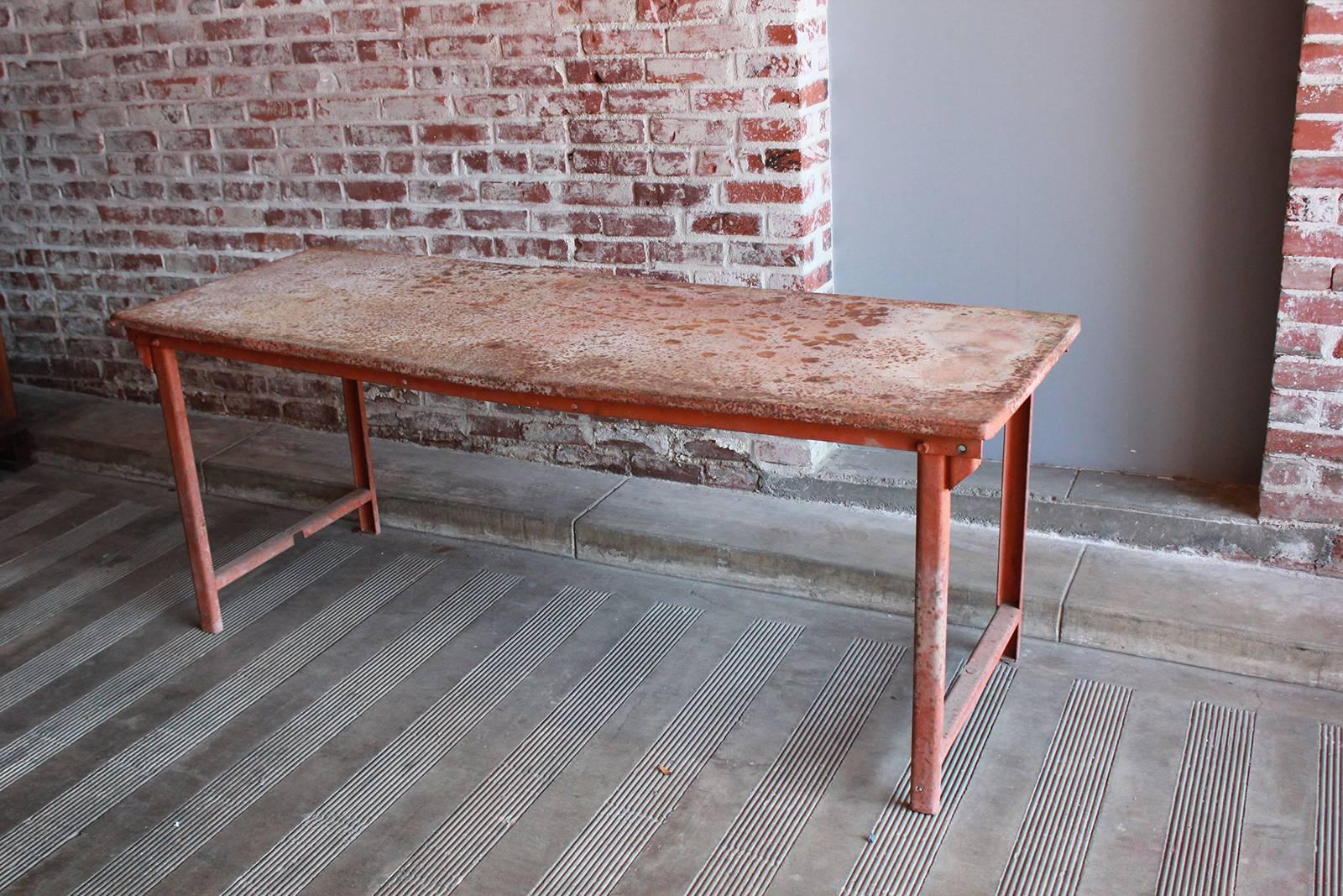 Red work table with rusted patina.