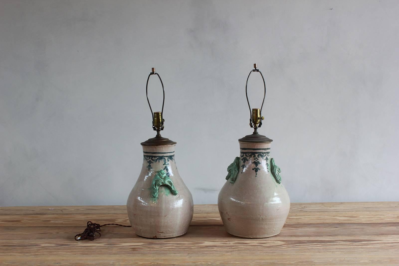 Pair of ceramic lamps with celadon glazed embellishments and blue details.