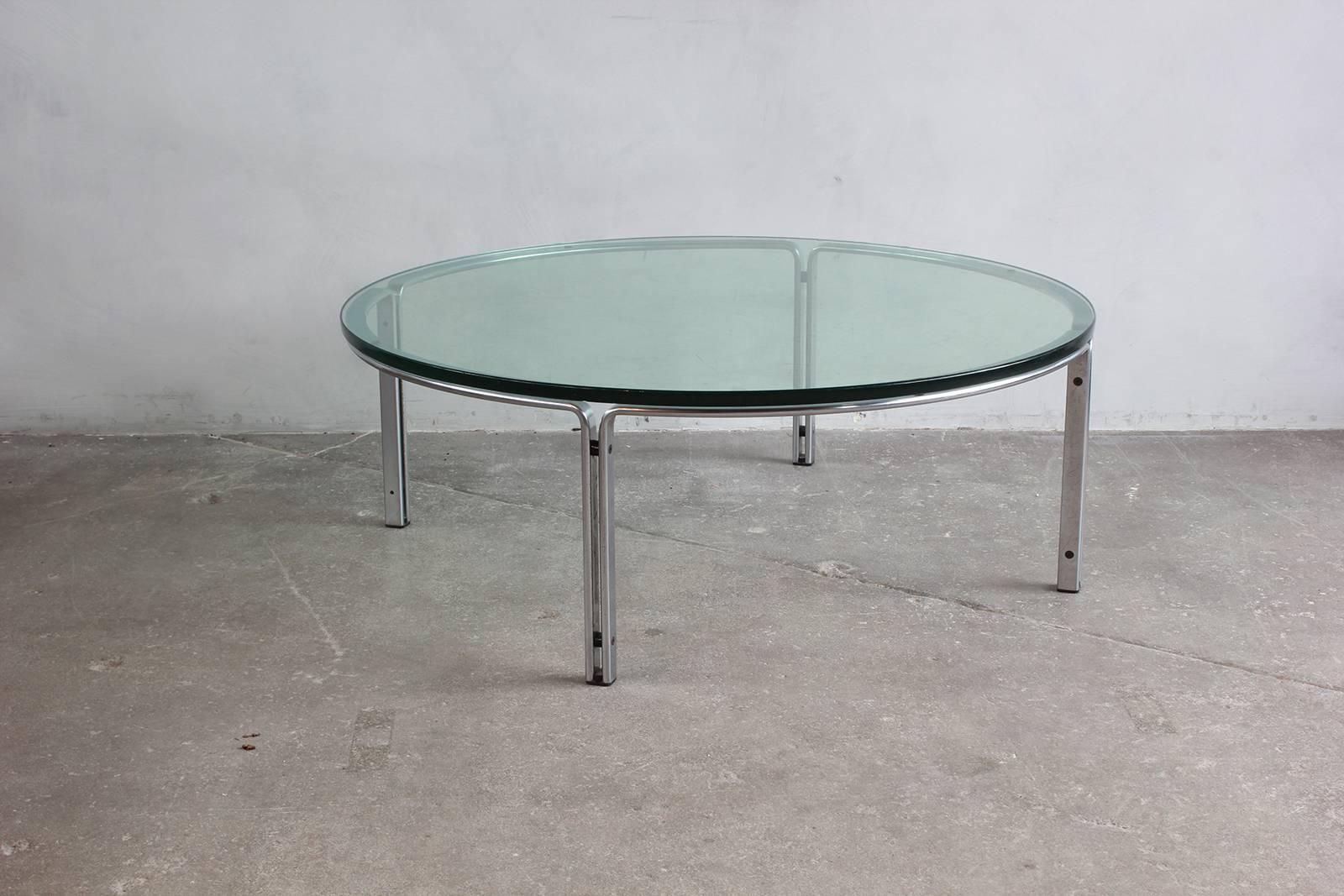 Round metal and steel coffee table with glass top.