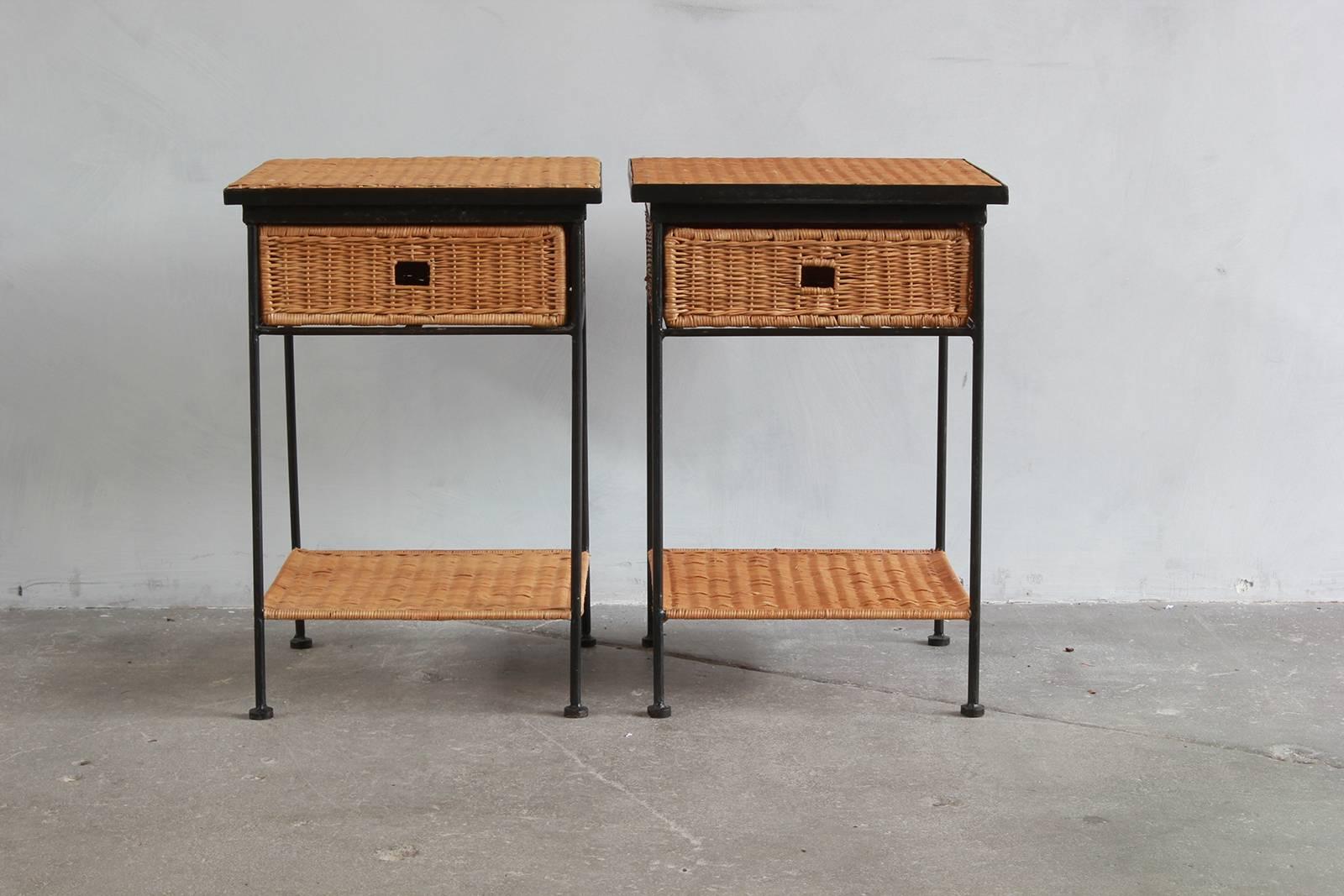 Pair of iron and wicker side tables with slide out drawers and lower shelf.