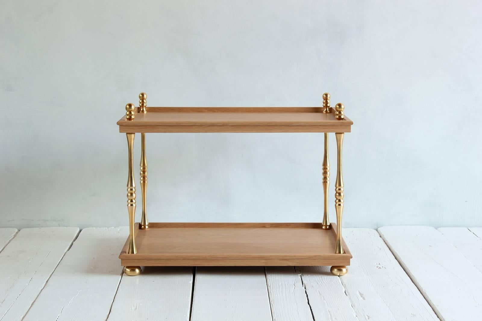 Turned brass side table made of solid unlacquered brass turned finials. Tabletop and base are made of solid white oak.