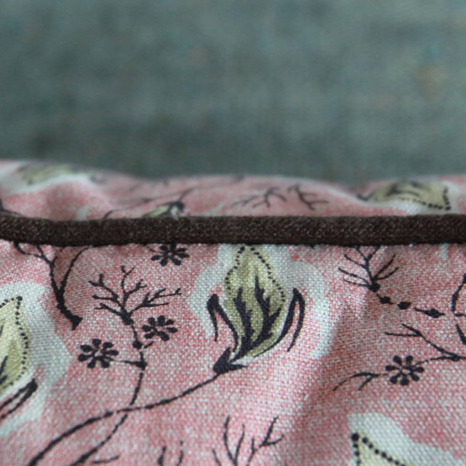 NK collection pillow. Claremont dusty pink textile with green leaf motif and brown linen contrast piping.