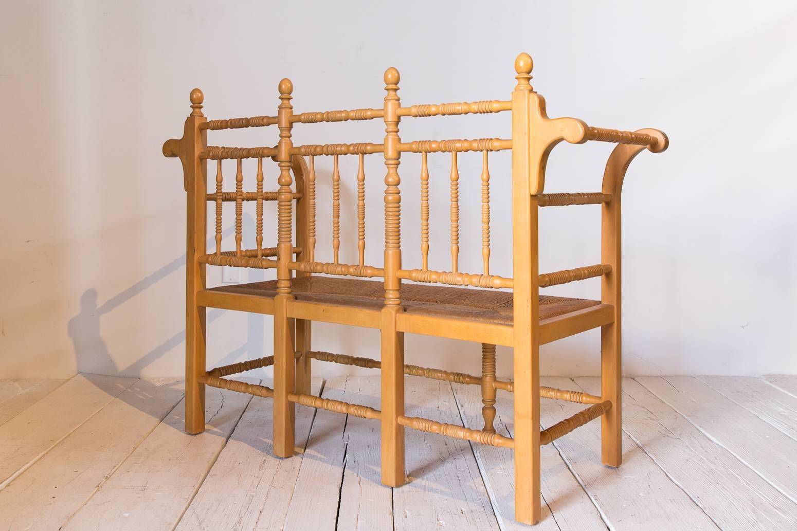 Early 20th Century Edwardian Style Light Oak Spindle Bench with Rush Seat and Curved Arms