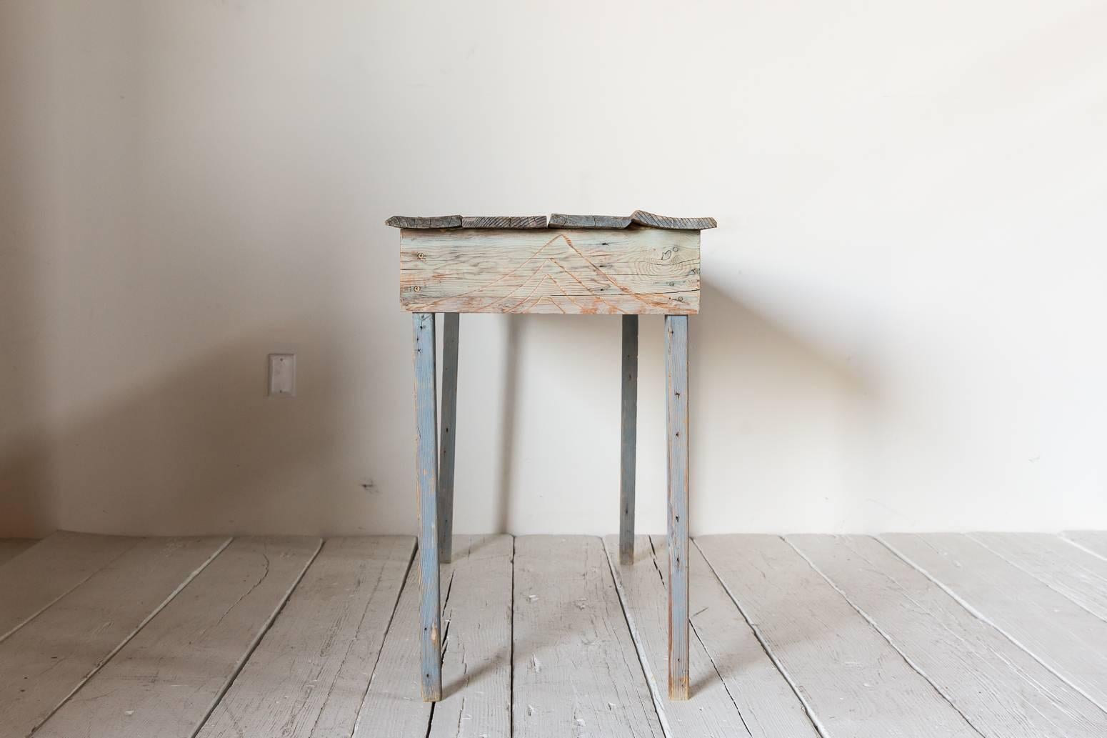 Primitive blue painted South Western style console table with geometric carved details.
