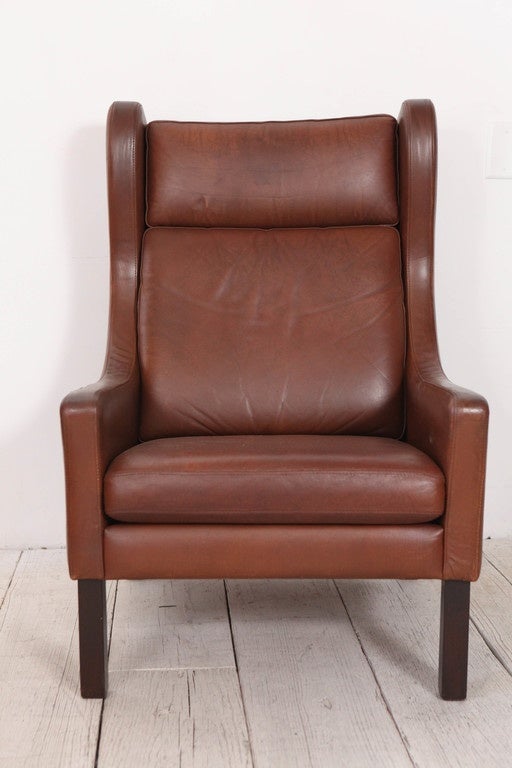 Handsome pair of cognac leather wingback chairs from Denmark in the style of Borge Mogensen.