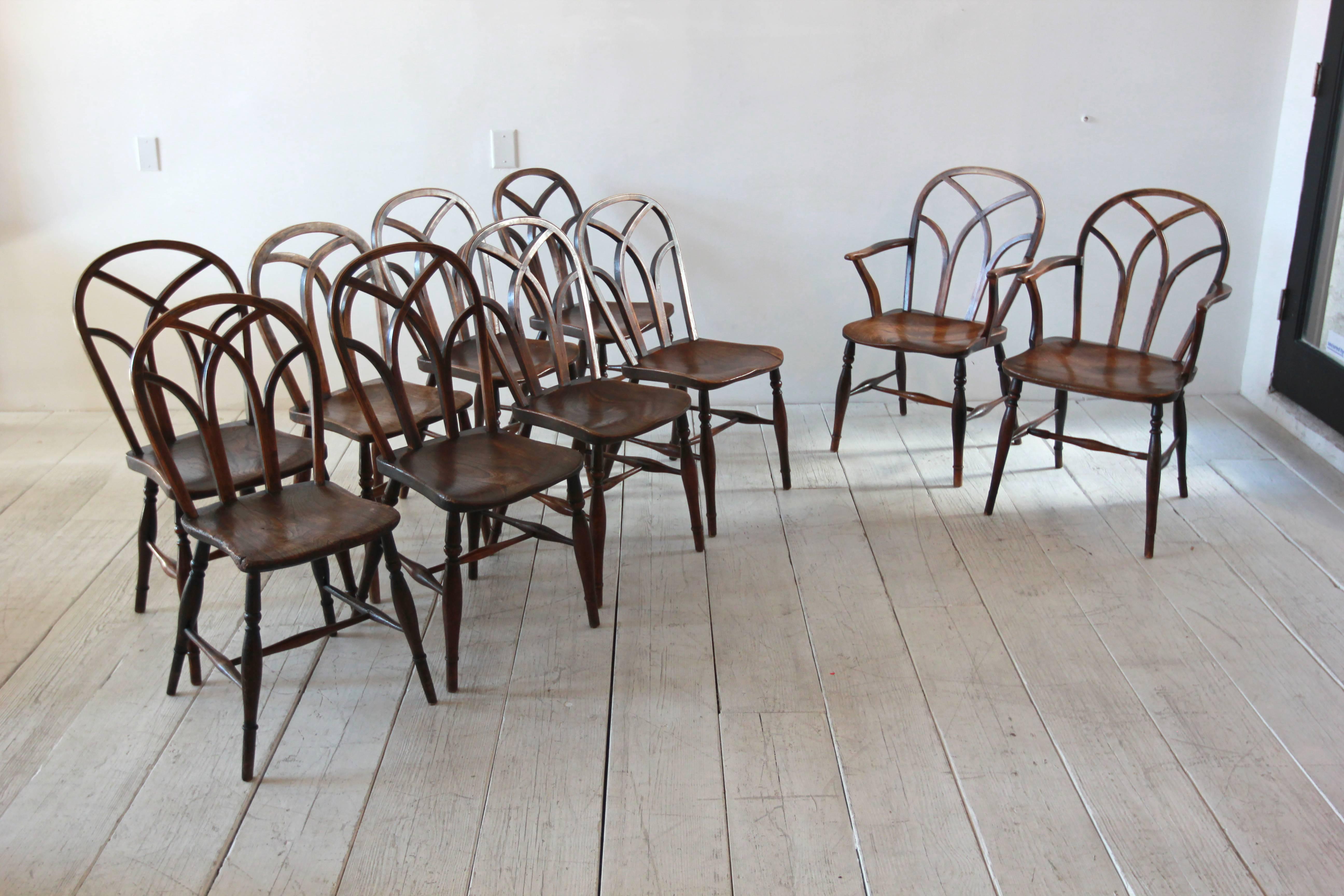 Set of ten farmhouse style dining chairs with cathedral style backs. Two armchairs and eight side chairs.