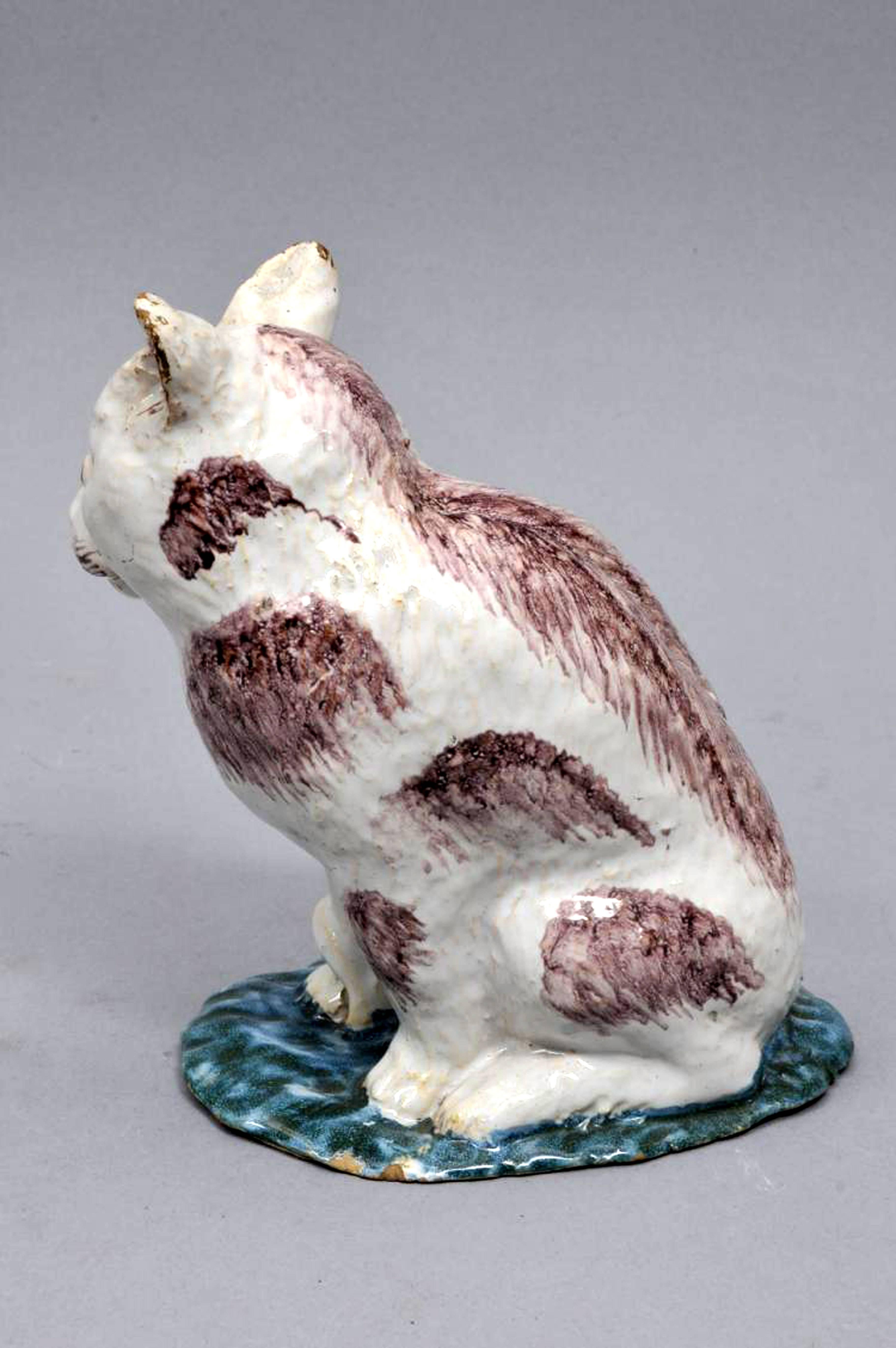 Brussels Faience model of a cat, 
Philippe Mombaers for the Rue de Laeken factory,
circa 1765-1785

The figure of a cat is depicted sitting on its hindquarters with manganese colouration on a green base.

Dimensions: 7 1/2 inches