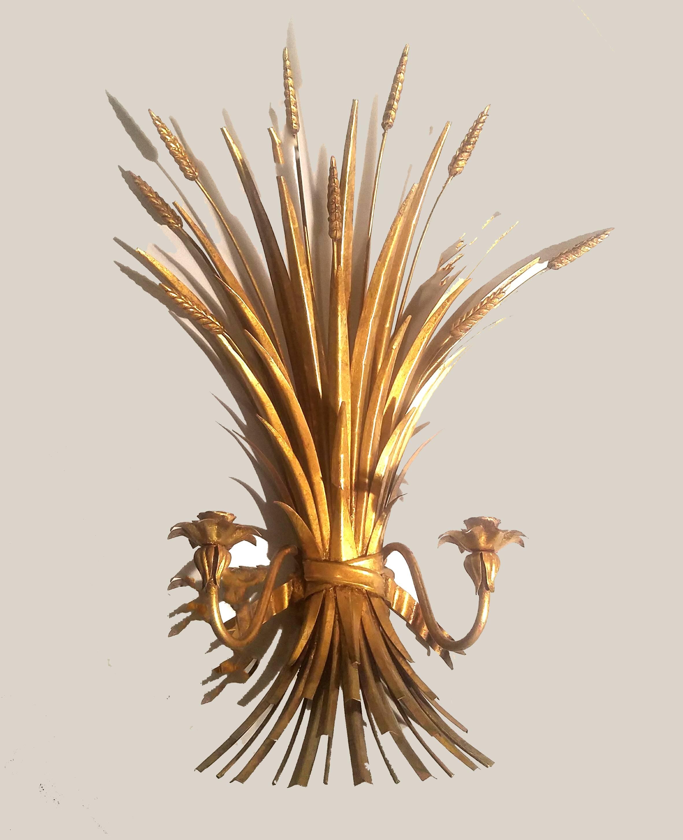 Hollywood Regency midcentury gilt metal wheat sheaf sconces,
Attributed to S. Salvadori - Firenze,
circa 1960s.

The pair of Hollywood Regency gilt metal sheaf of wheat wall sconces each have two candle arms. 

Dimensions: 25 1/4 inches high x