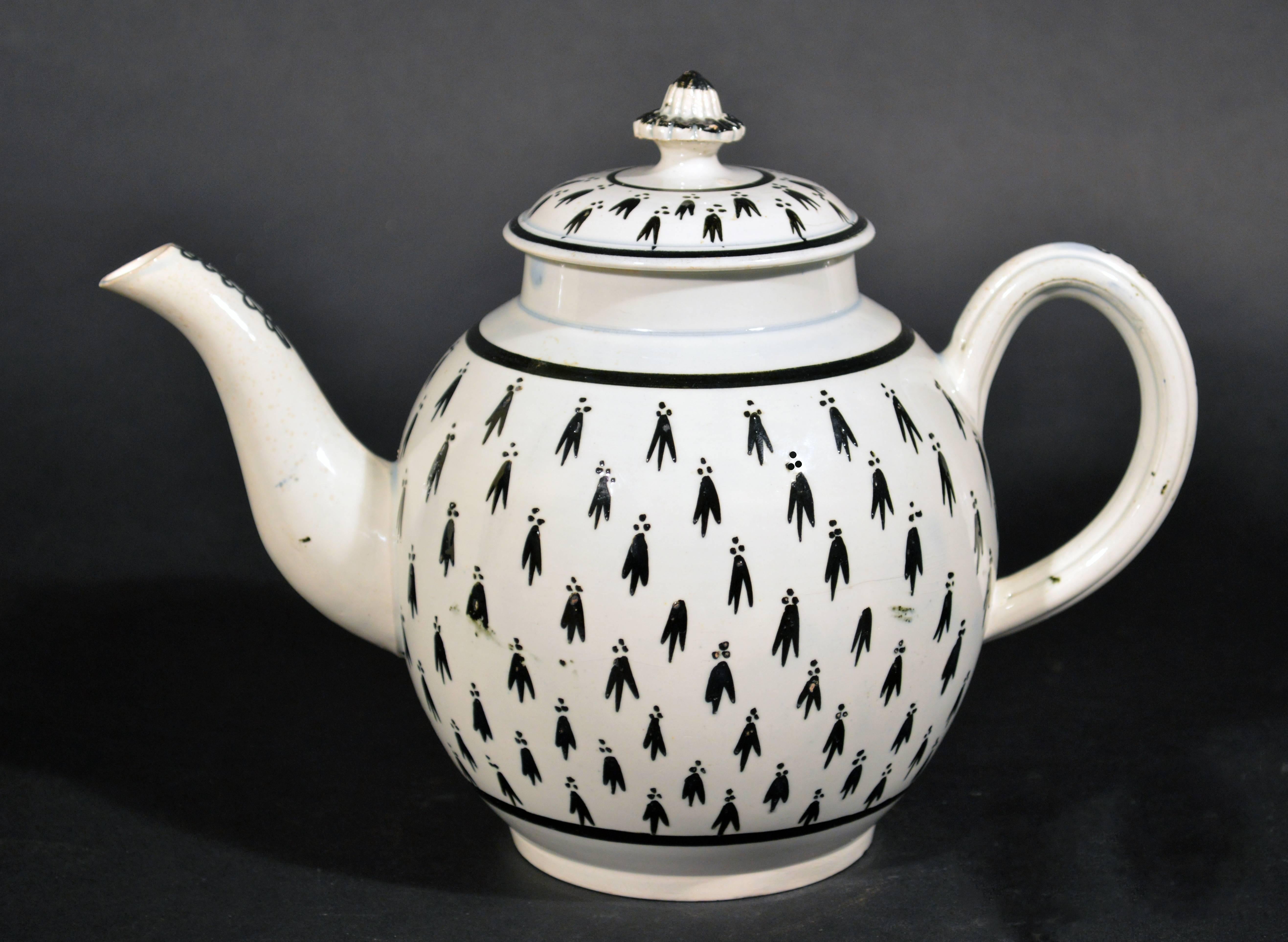A wonderful Georgian pearlware pottery teapot with exuberant and dramatic hand-painted 'Ermine' decoration. The teapot features a flower-form finial and interior hand-pierced strainer.