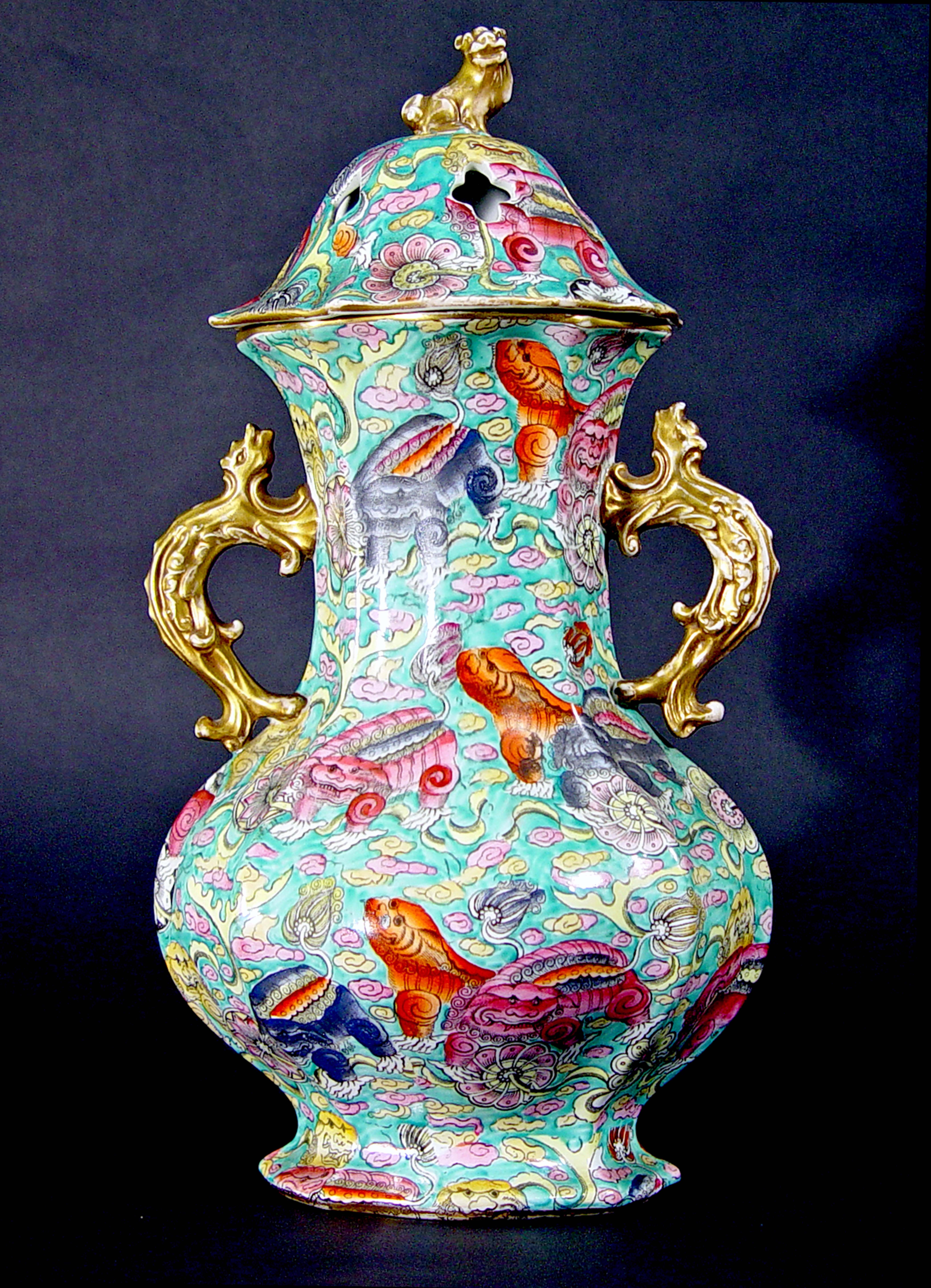 Mason's ironstone Chinoiserie vase in the Bandana pattern with a turquoise ground overlaid with different coloured kylins and flower-heads. The cover is pierced.

Reference: Mason's: The First Two Hundred Years, Gaye Blake Roberts, page 110-111.