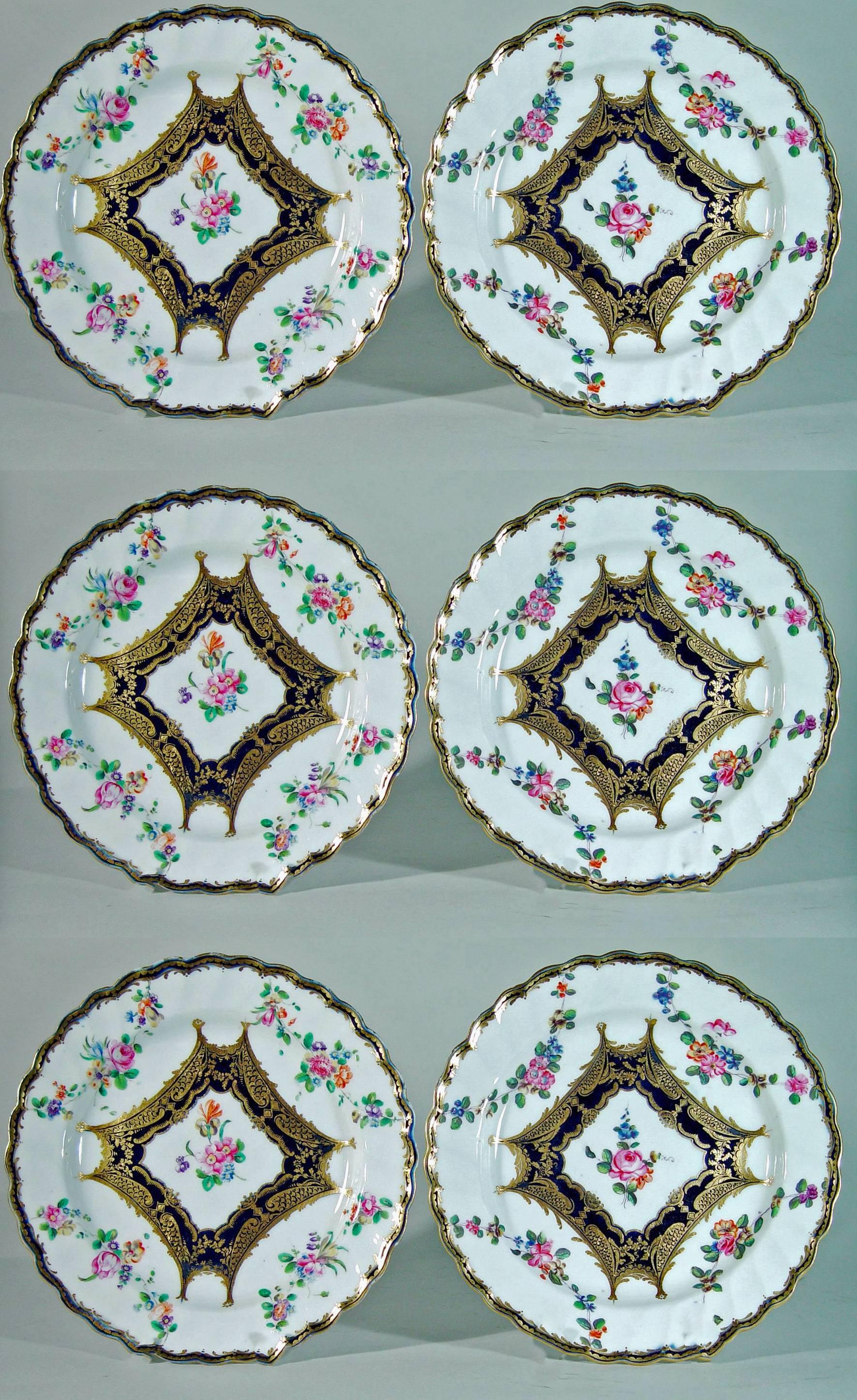 The rare Chelsea or Chelsea Derby Porcelain plates are painted in the center with a floral bouquet panel surrounded by a mazarine-blue border and fine gilt highlights of dentil work, fish scales, and flower heads.

The fish-scale gilding is as