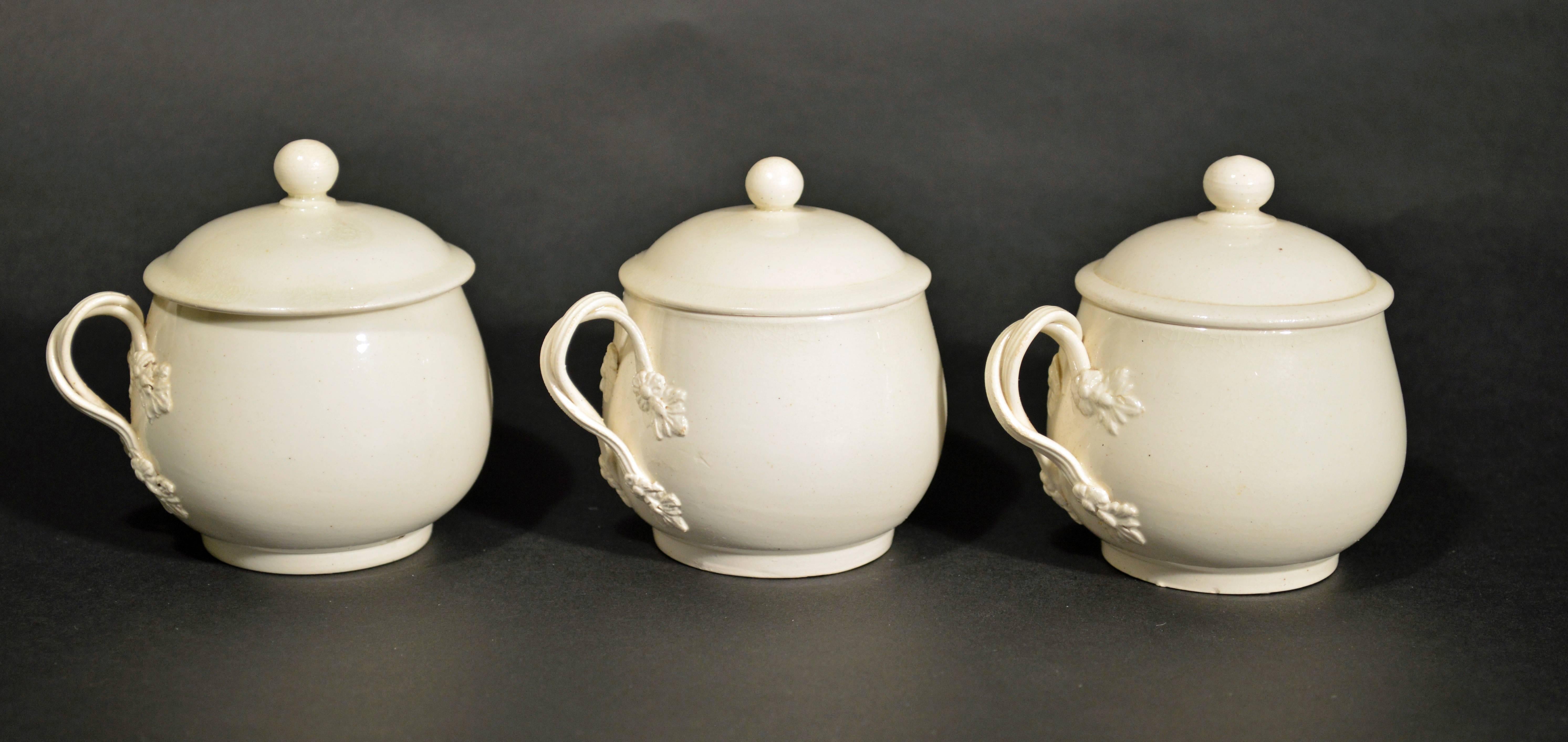 The rare creamware pot-de-creme pots are of circular bombée form with a plain circular button finial. The handles are double-loop reeded strapwork with leaf terminals.

Pot de crème
From Wikipedia, the free encyclopedia

Pot de crème is a