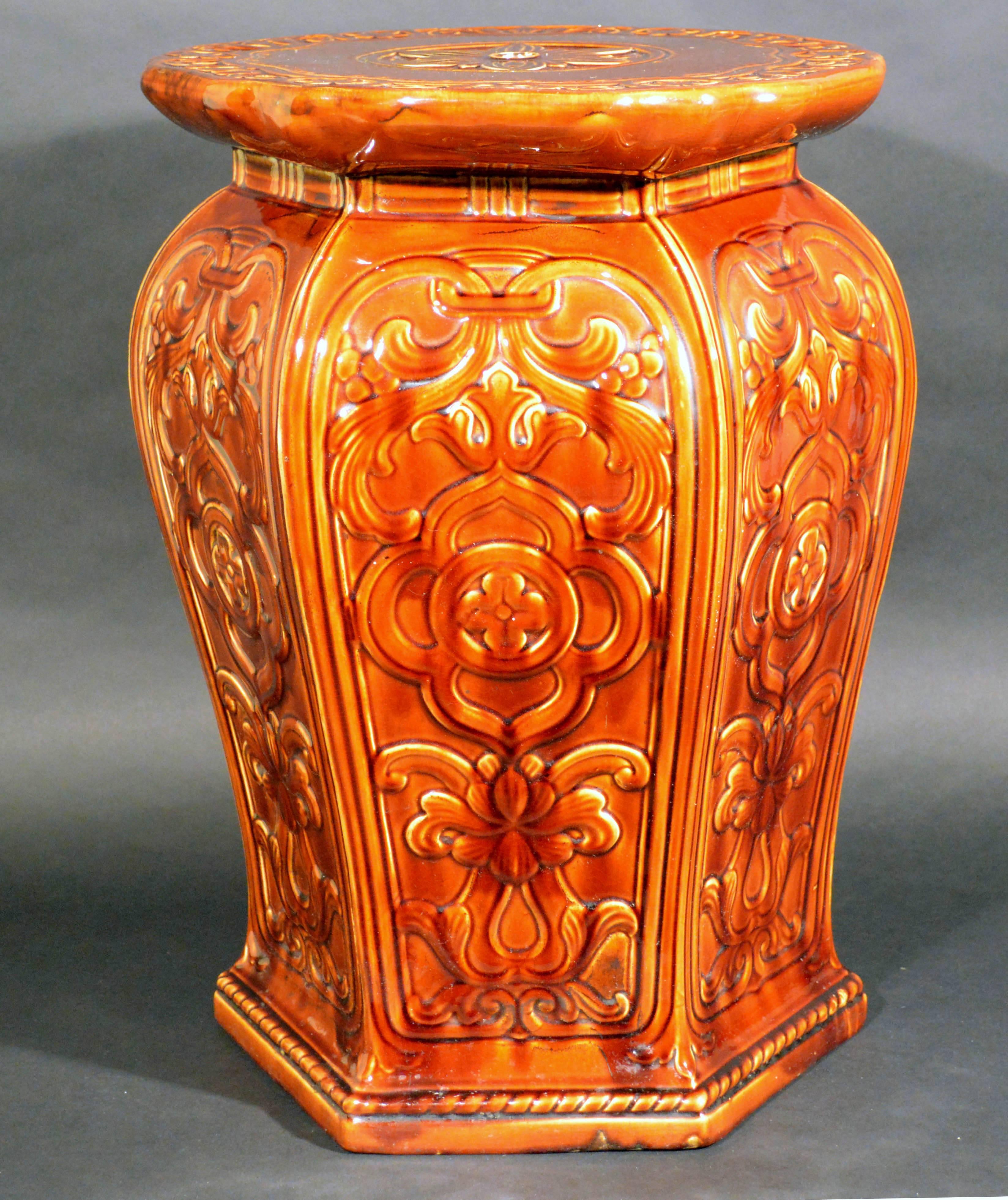 The Augustus Welby Pugin Minton majolica garden seat from the Arts & Craft period is a golden brown.  

The seat  with a central flowerhead on the circular top over a hexagonal, baluster-form body is decorated with polychrome arabesques of