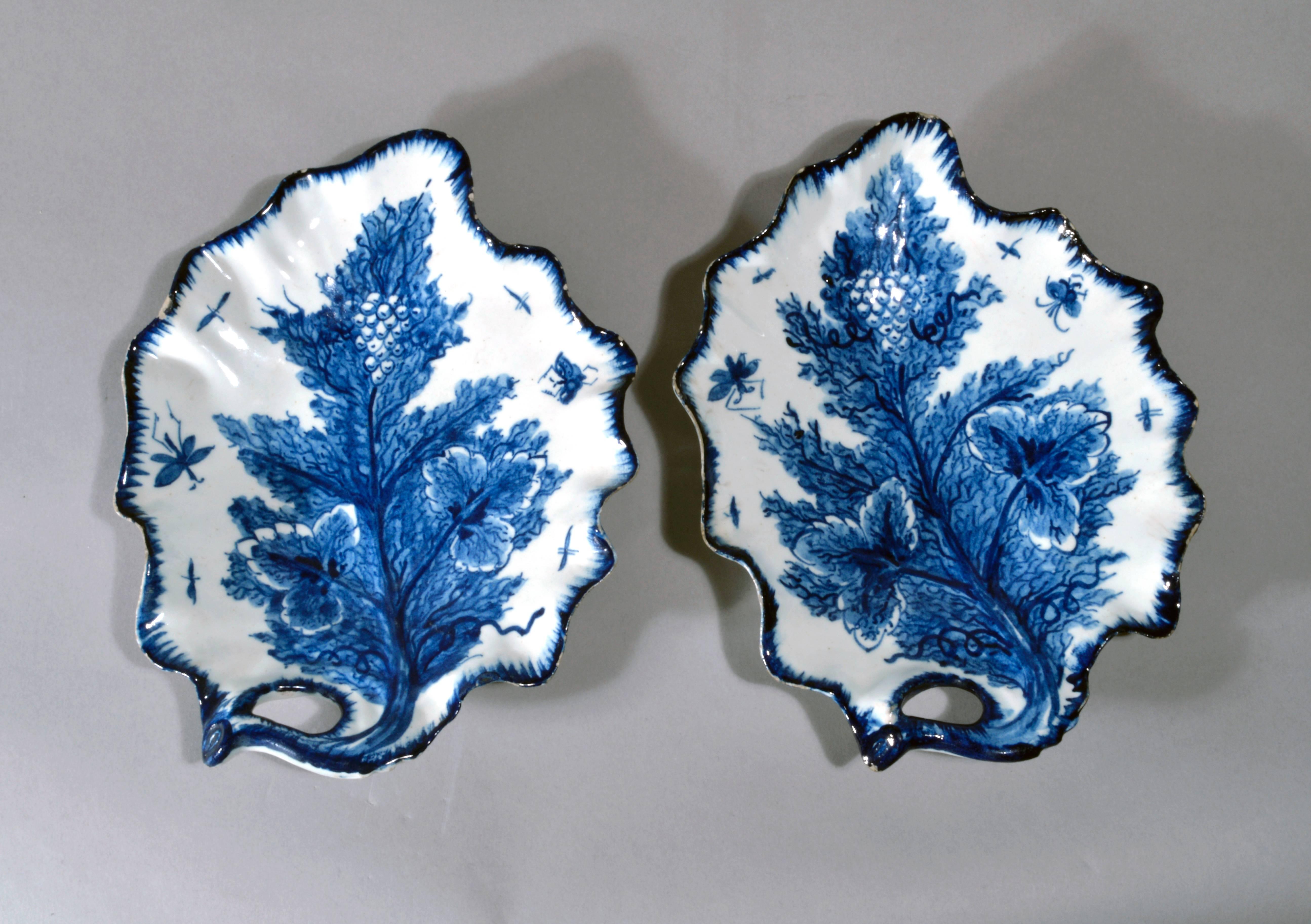 The Bow porcelain leaf dishes moulded and painted trompe l'oeil dishes are in the form of a vine leaf and are painted with vine leaves, grapes and insects in underglaze blue.  Minor frits to rim.

Reference: Bow Porcelain, Gabszewicz & Freeman,