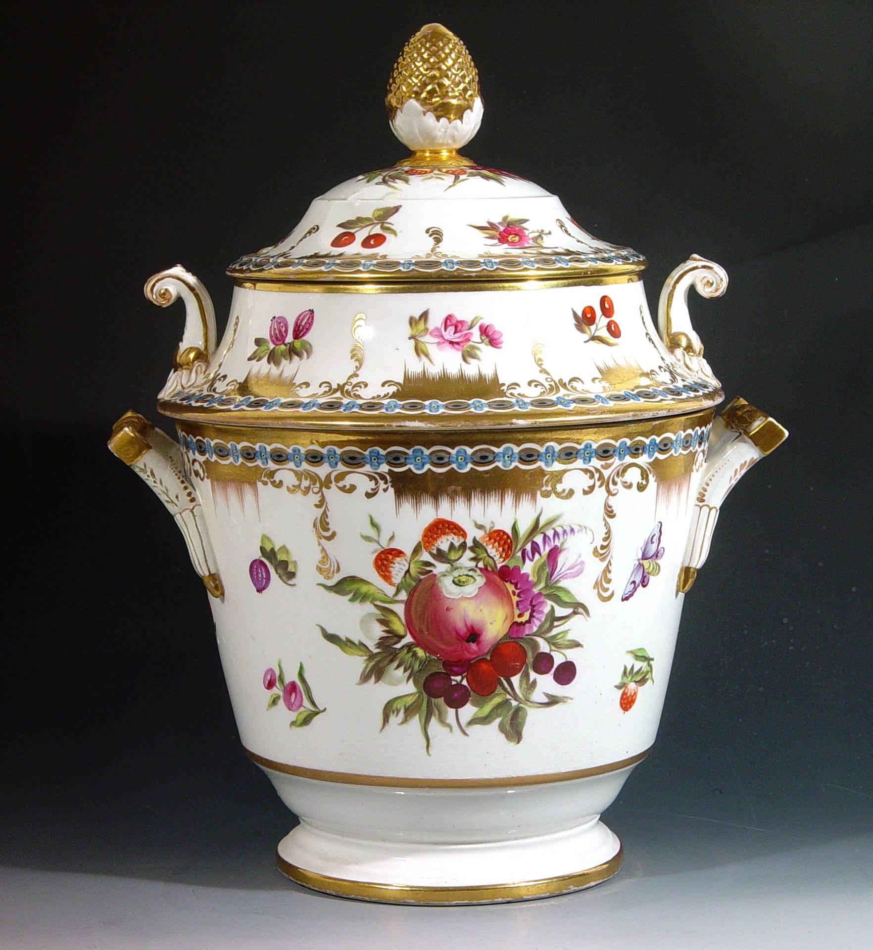 The Coalport fruit cooler with a double cover is finely painted with fruit, flowers and butterflies on each side in the Chelsea style.