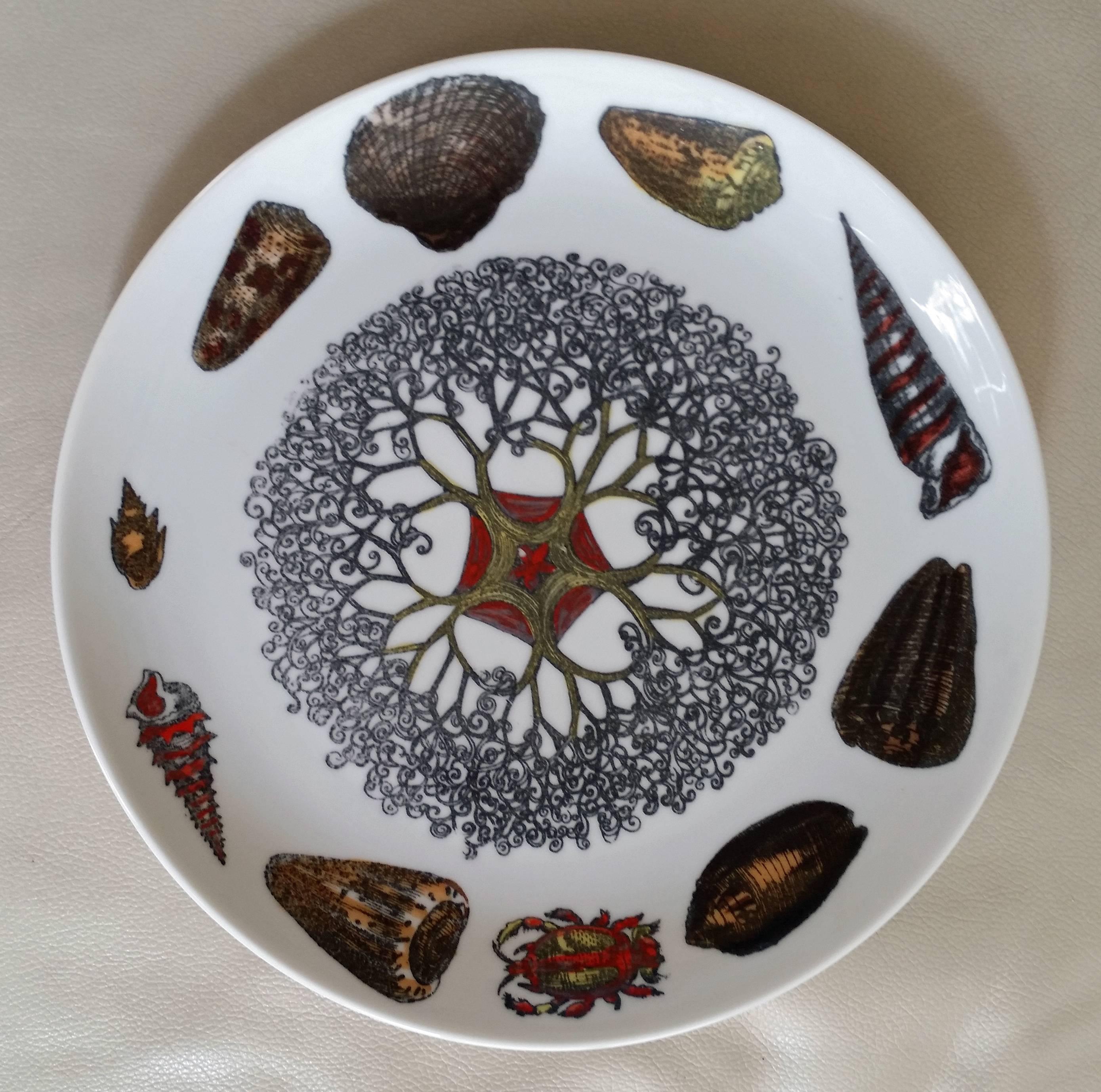 Piero Fornasetti's whimsical and colourful Conchiglie (seashell) pattern features a different sea creature filling the center well of each plate, surrounded by assorted sea animals, shells, mollusks and fishes. While many of the creatures are