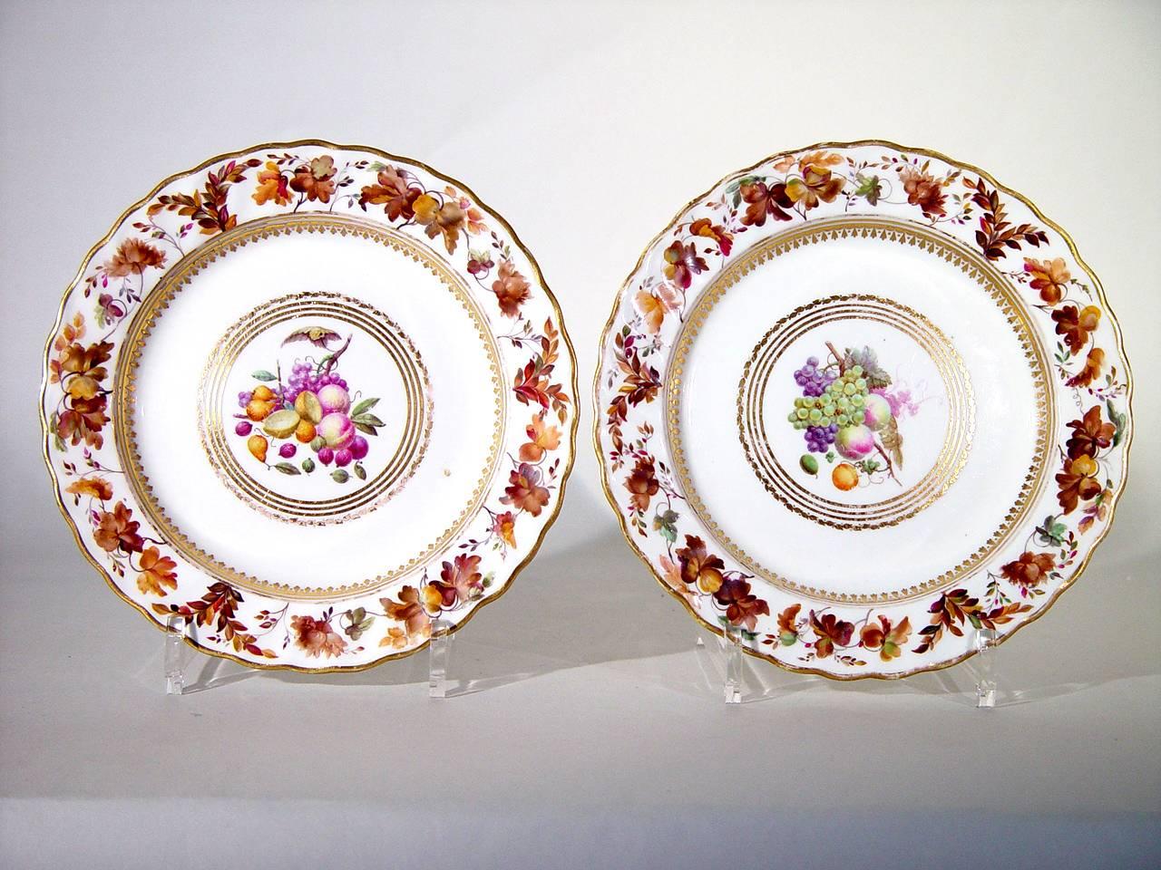 The beautiful and stylish Derby porcelain set of six plates are painted by William Longden with fruit within a heart-shaped gilt border. The fruit depicted include grapes, plums, strawberries, raspberries, and apples amongst others. The rim in