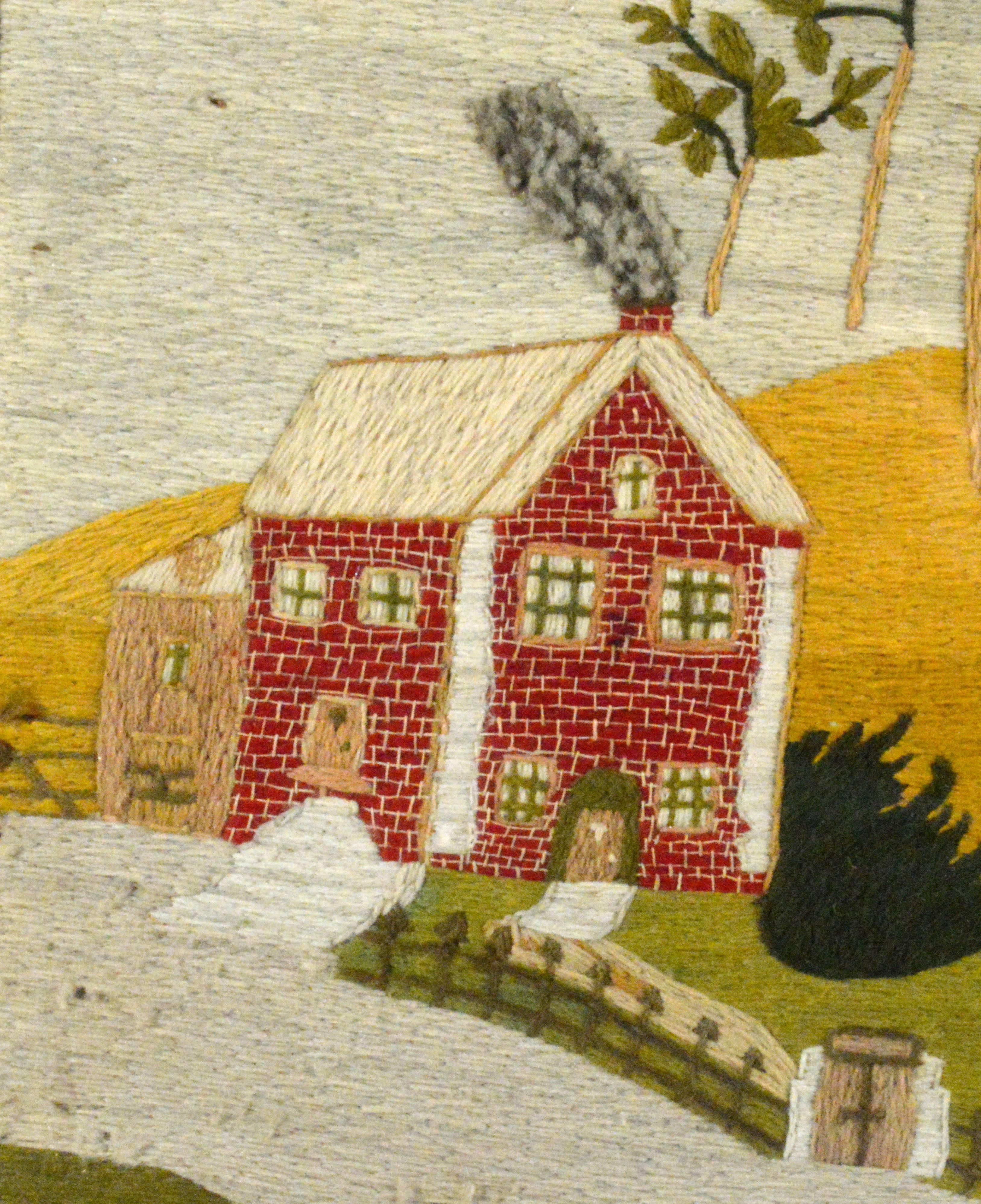 The sailor's woolwork or woolie depicts a landscape scene with a young woman walking along a path to a red brick house past a small garden which is fenced with bricks and metal railings. In the foreground on the path is a groom and his horse and