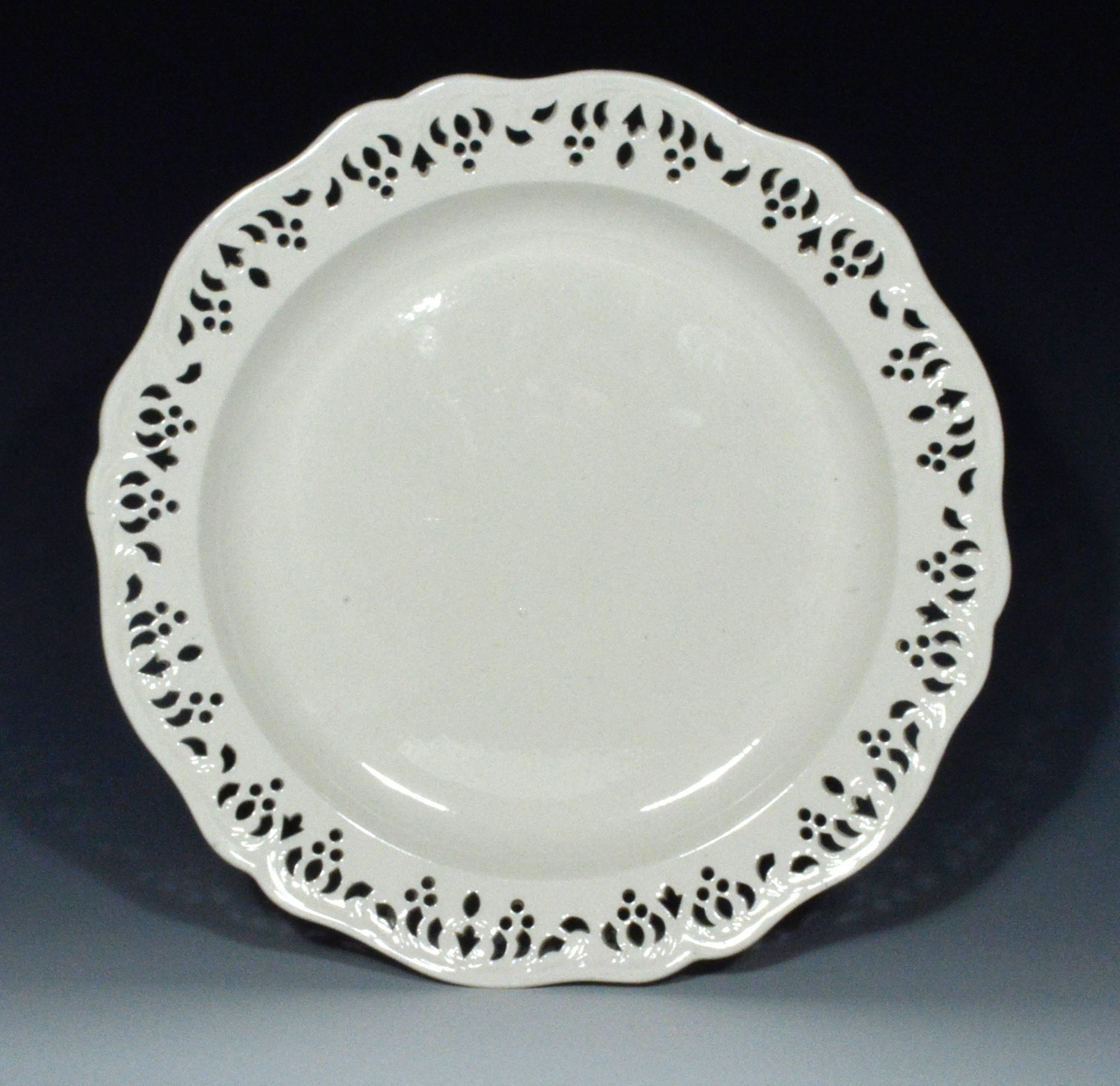 The Wedgwood plain-undecorated plates are of circular form with openwork shaped rims.

Impressed: Wedgewood.