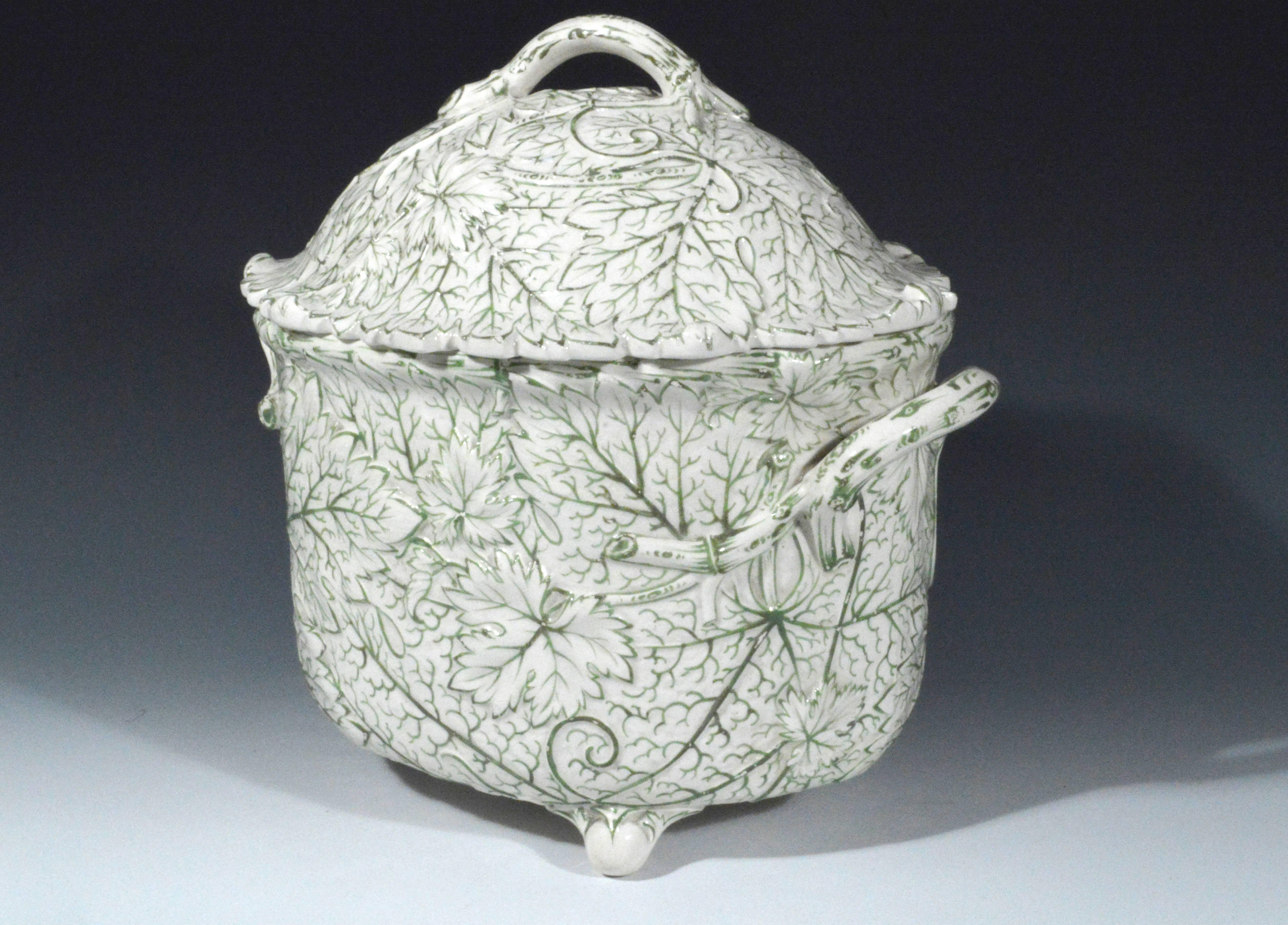 The pottery tureen with the body and cover formed by overlapping leaves and the ribbing of the leaves in a light green.

Mark: Wedgwood impressed and date code BCF, the F for 1877.