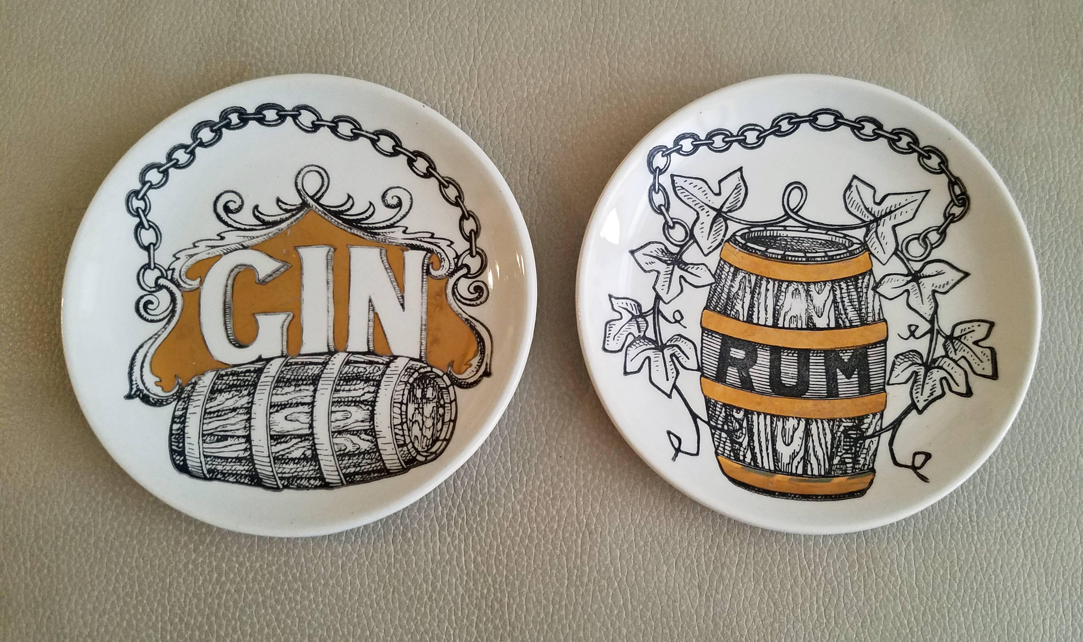 The charming complete set of coasters includes Gin, Rum, Sherry, Madeira, Port, Rhenish, Brandy and Whiskey. Each coaster is printed in black and white and highlighted in gilt.

Mark: The name of pattern-Vini E Liquori within a bottle, the