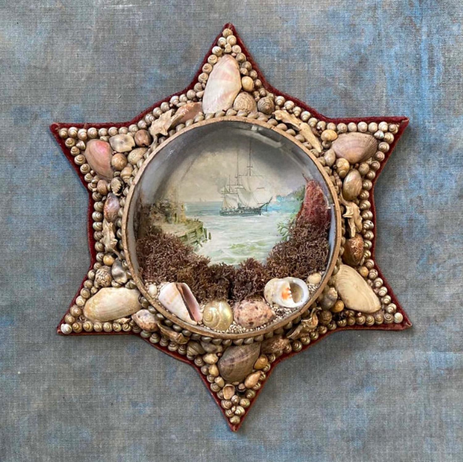 Edwardian Shellwork Valentine Diorama,
Circa 1900.

A large circular Edwardian star-shape shellwork diorama with beveled glass, features a chromolithograph of a sailing ship passing a lighthouse. Surrounding the image on the exterior is a display of