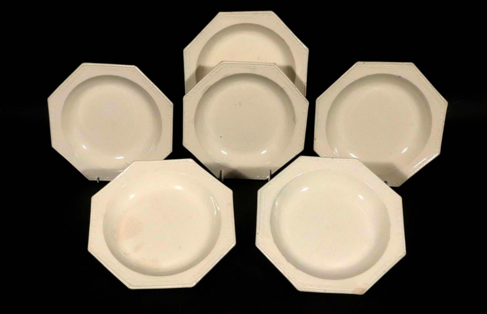 English Plain Creamware Soup Plates- a Set of Six,
Circa1780-90

The plain creamware soup plates have a deep central bowl and a molded rim with a bar and circle design.

Dimensions: 8 1/4 inc diameter x 1 inch high.

Mark: Impressed with