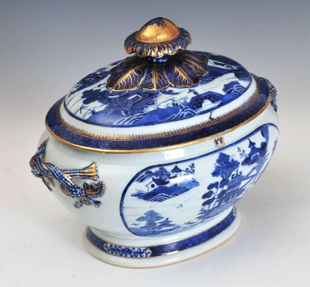 The blue and white armorial porcelain tureen from 1790-1810 for the Irish family O'Neill of Upper Claneboys is of bombe-form with double loop handles and flower-head handle terminating in large blue leaves. The handles, finial and rim decorated in
