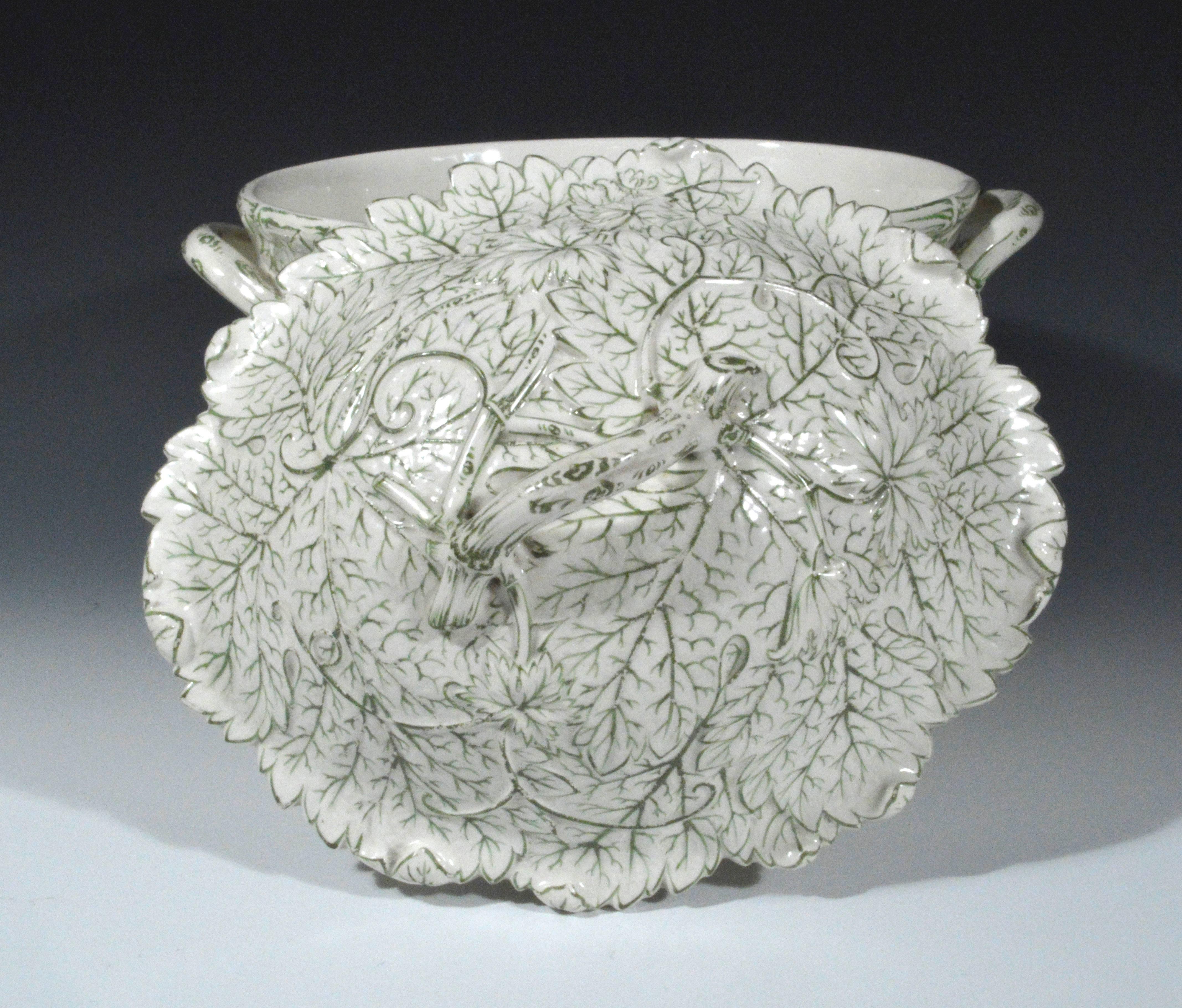 The Wedgwood Drabware pottery tureen with the body and cover formed by overlapping leaves and the ribbing of the leaves in a light green.

Mark: Wedgwood impressed and date code BCF, the F for 1877.