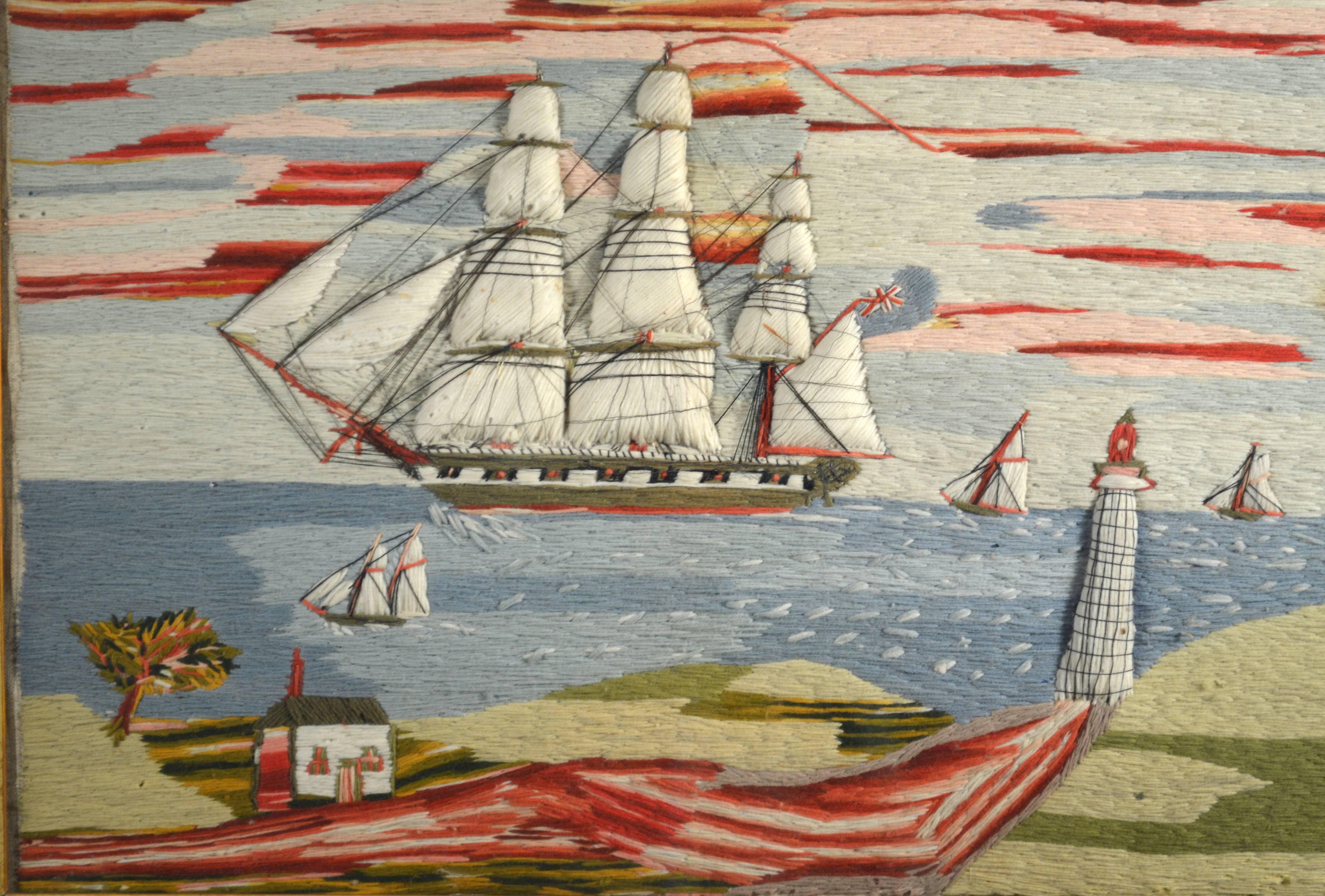 The fabulous and unusual Folk Art sailor's trapunto woolwork is very charming and dramatic depicting a large three-masted ship passing close-in to shore with other small vessels nearby. The shoreline shows a trapunto lighthouse and a muddy path