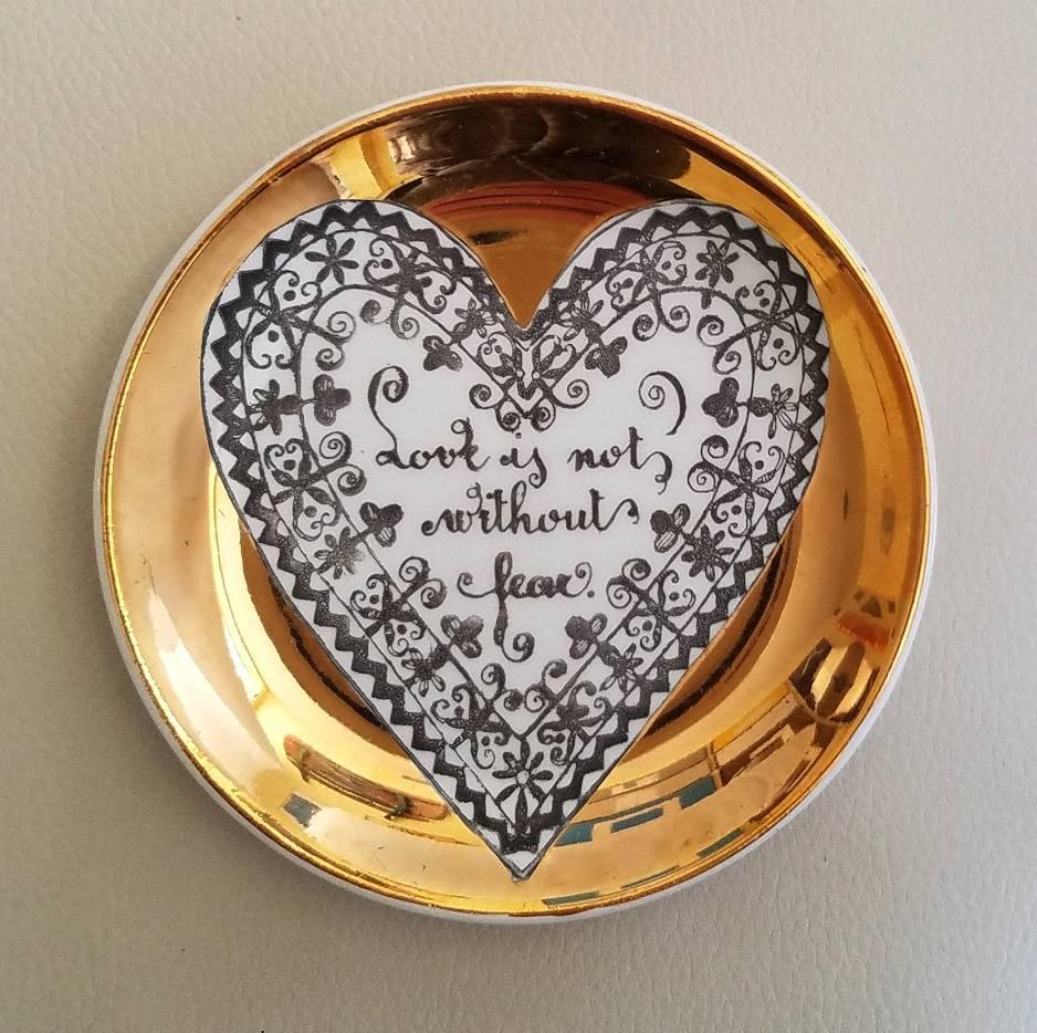 Piero Fornasetti porcelain coaster set with love, hearts and sayings, circa 1960s.

 Each coaster has a central white heart on a gold ground. Within each heart is a saying about love framed by a different heart-shaped border. They rest in their