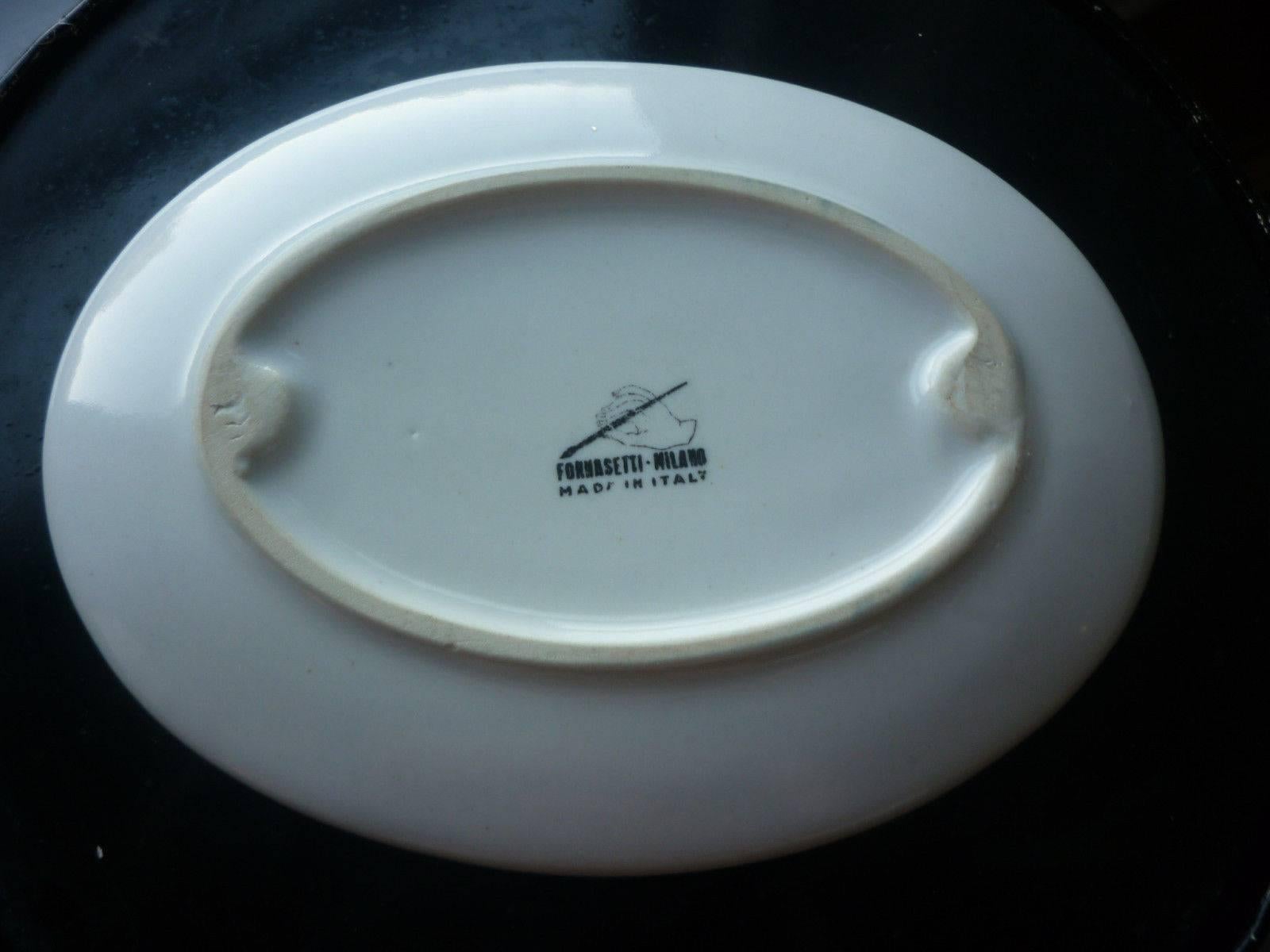 Piero Fornasetti surrealist double Le Arpie Gentili dish.

Rare oval dish from the 1960s depicts two arpies, creatures with bird bodies and women's heads, within wire bird cages. I have never seen a depiction of two on one piece together like