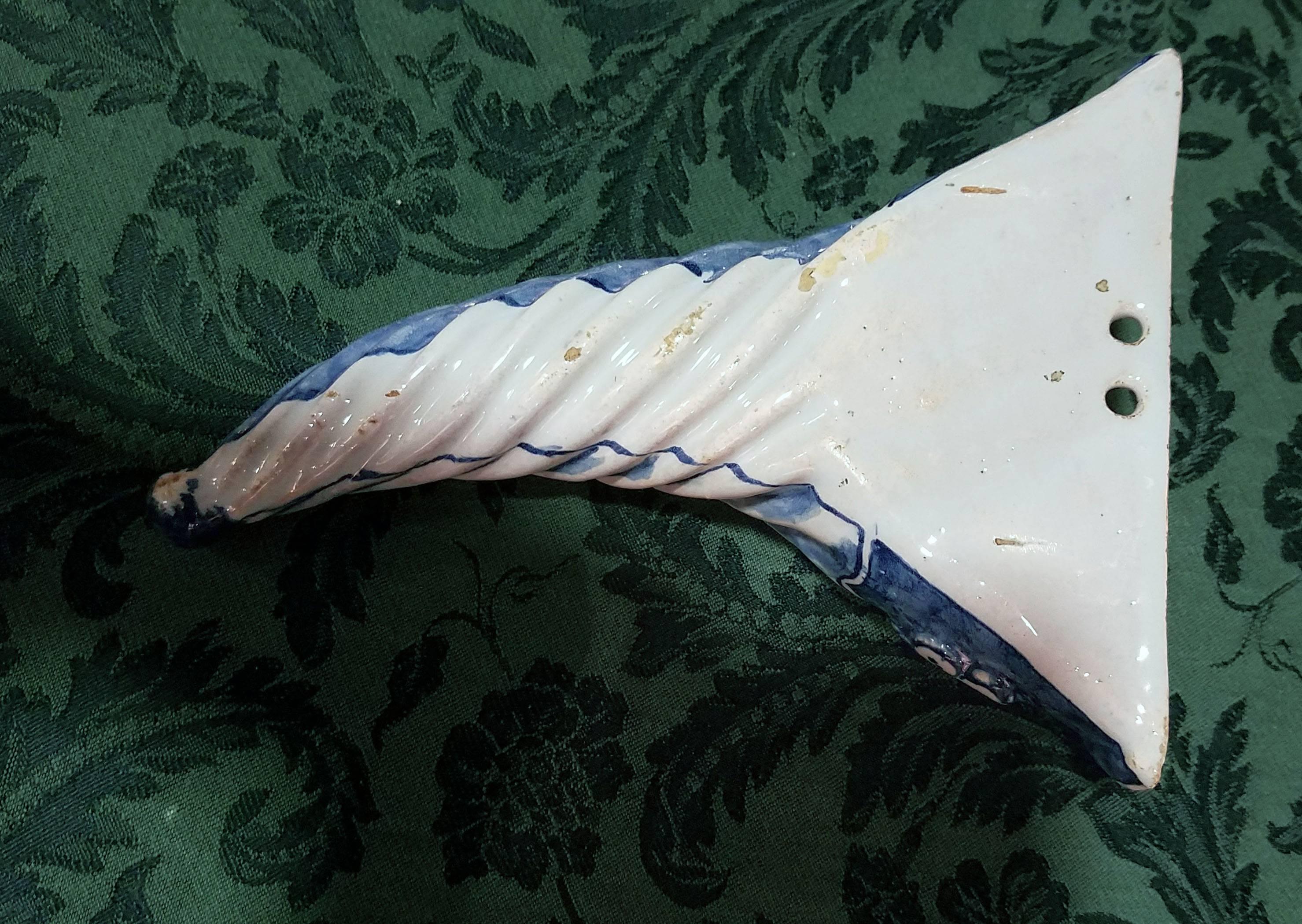 

The pair of blue and white Liverpool Delftware pockets with a cornucopia shape with the upper section with moulded florets on a 