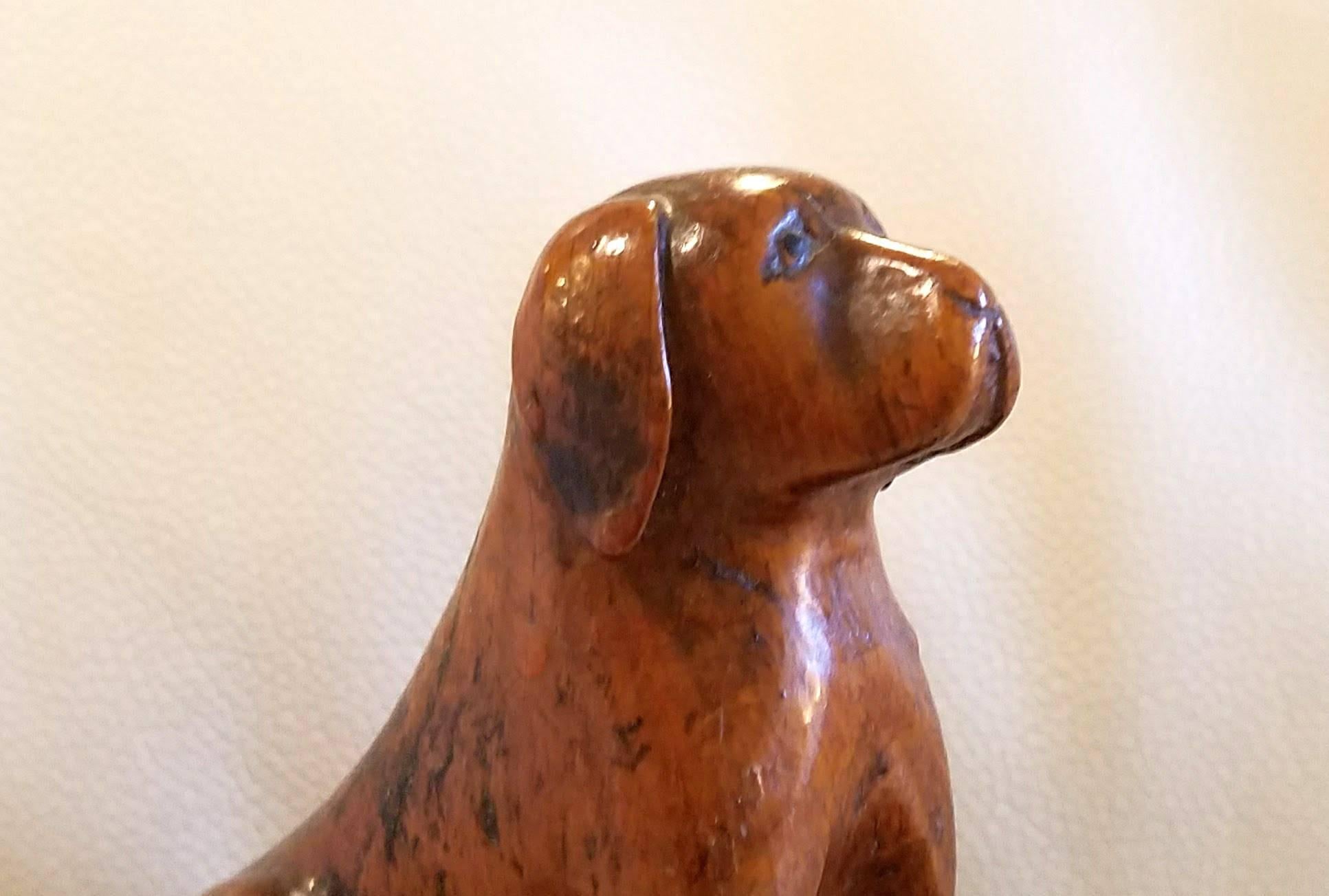 Oak treen dogs, probably pugs, 19th century.

The dog and bitch sit on their haunches looking at each other with endearing expressions. Carved in solid oak with a naturalistic base, these portraits probably depict someone's favourite