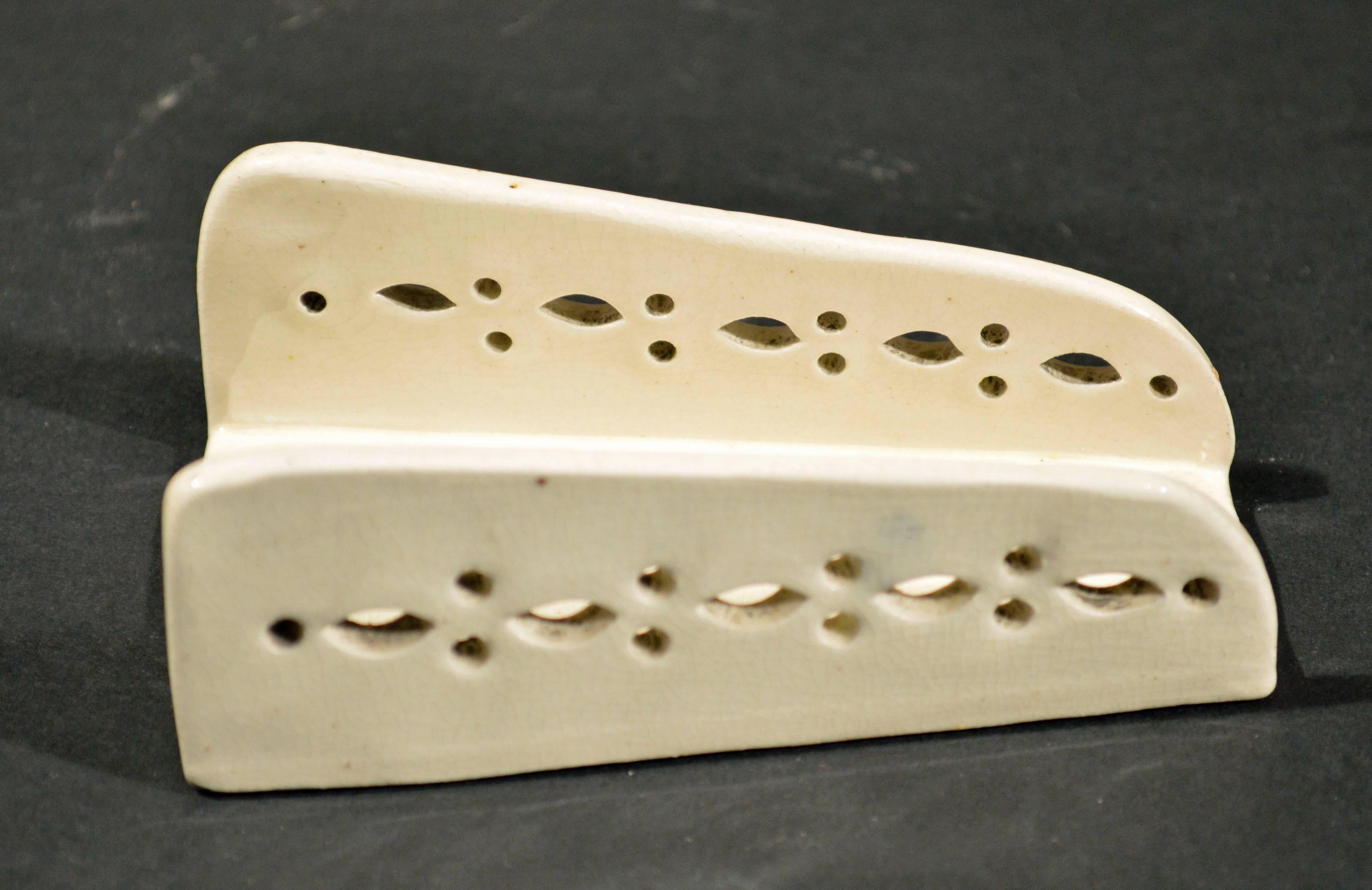 English Creamware Set of Four Asparagus Servers or Shells, 
circa 1780-1800.

The four creamware openwork holders are formed like a channel with rounded edges and a flat base, the sides with openwork in the form of stylized flower-heads.

These