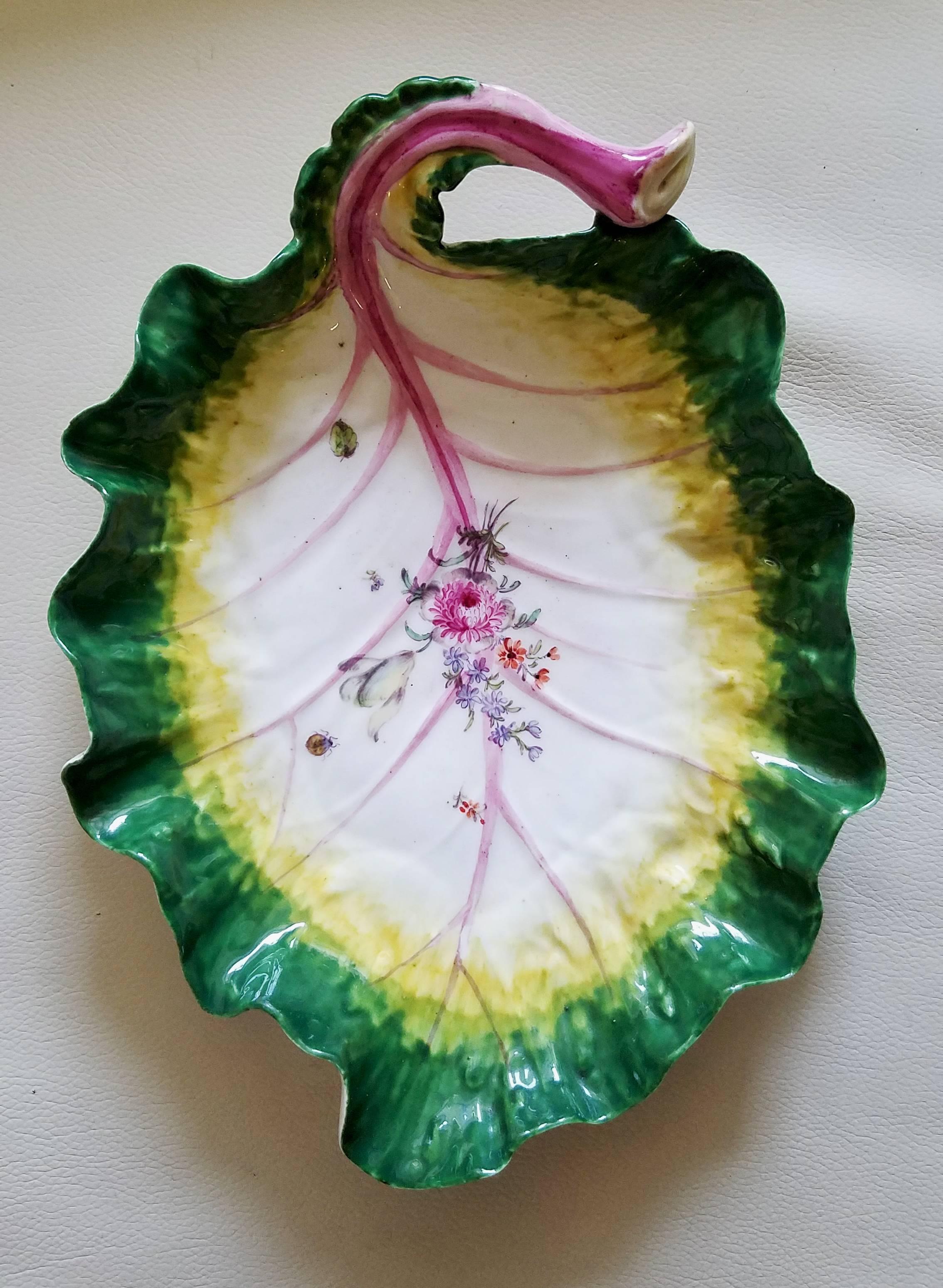 Pair of Chelsea Porcelain Tromp L'oeil leaf dishes, circa 1755

The large deep porcelain dishes are modelled in the form of a leaf with a dark green border with a yellow interior and purple veining. Across the center of each is a floral