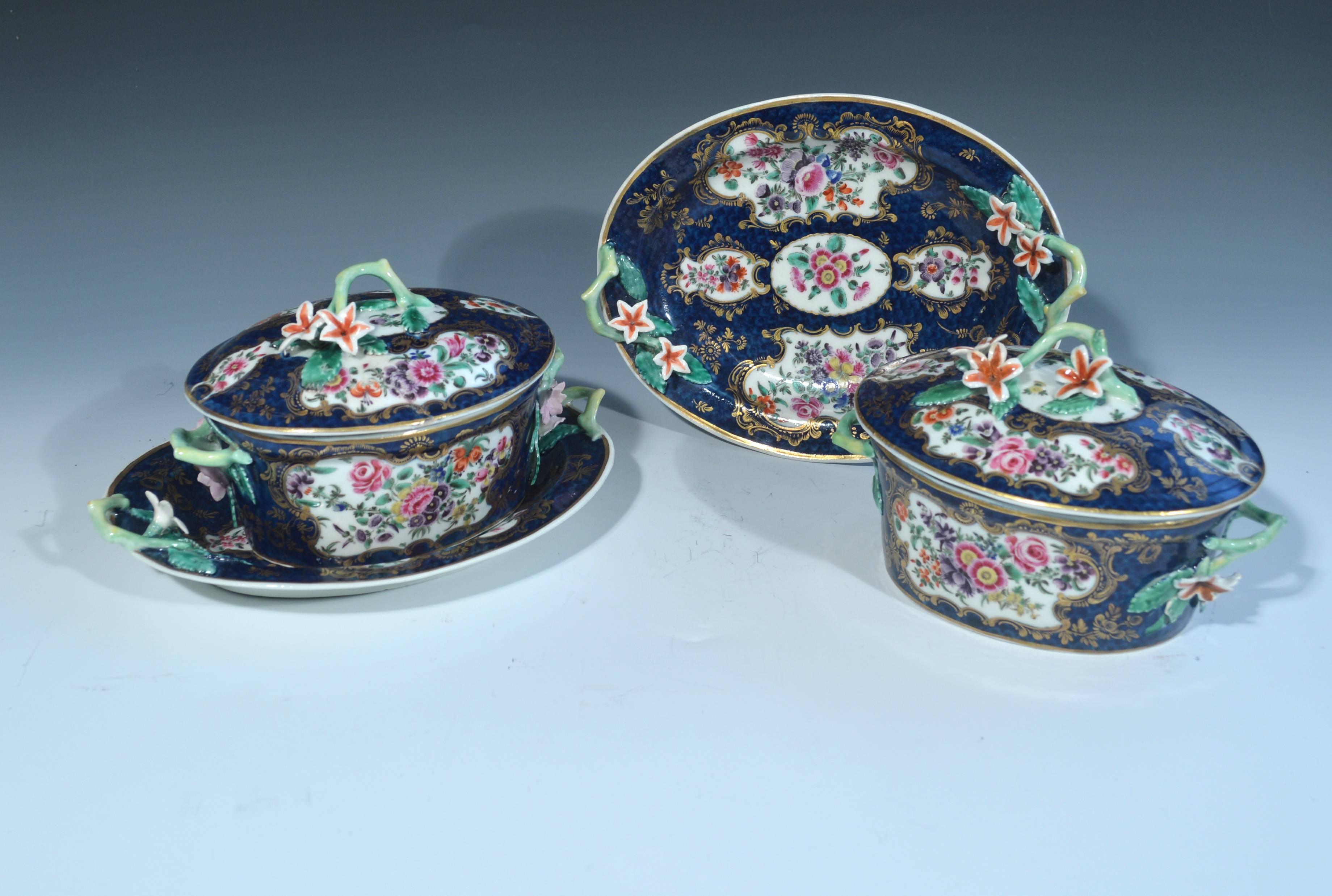 First period Worcester porcelain Mazarine blue scale botanical sauce tureens covers and stands, circa 1765-1775.

The outstanding botanical oval sauce tureens, covers and stands with a blue scale ground are highlighted with panels of flowers and