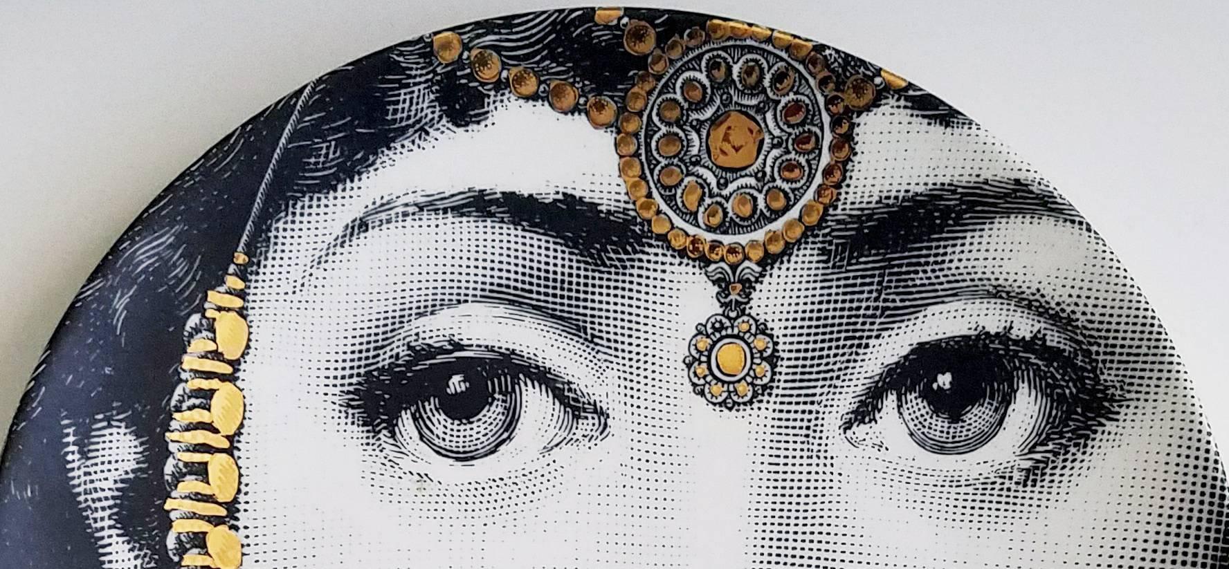 Fornasetti Tema E variazioni gold-plate, Number 228, Image of Lina Cavalieri.

A variation of Fornasetti's Tema E Variazioni series based on the face of the opera singer Lina Cavalieri.

Piero Fornasetti's most famous work is without a doubt,