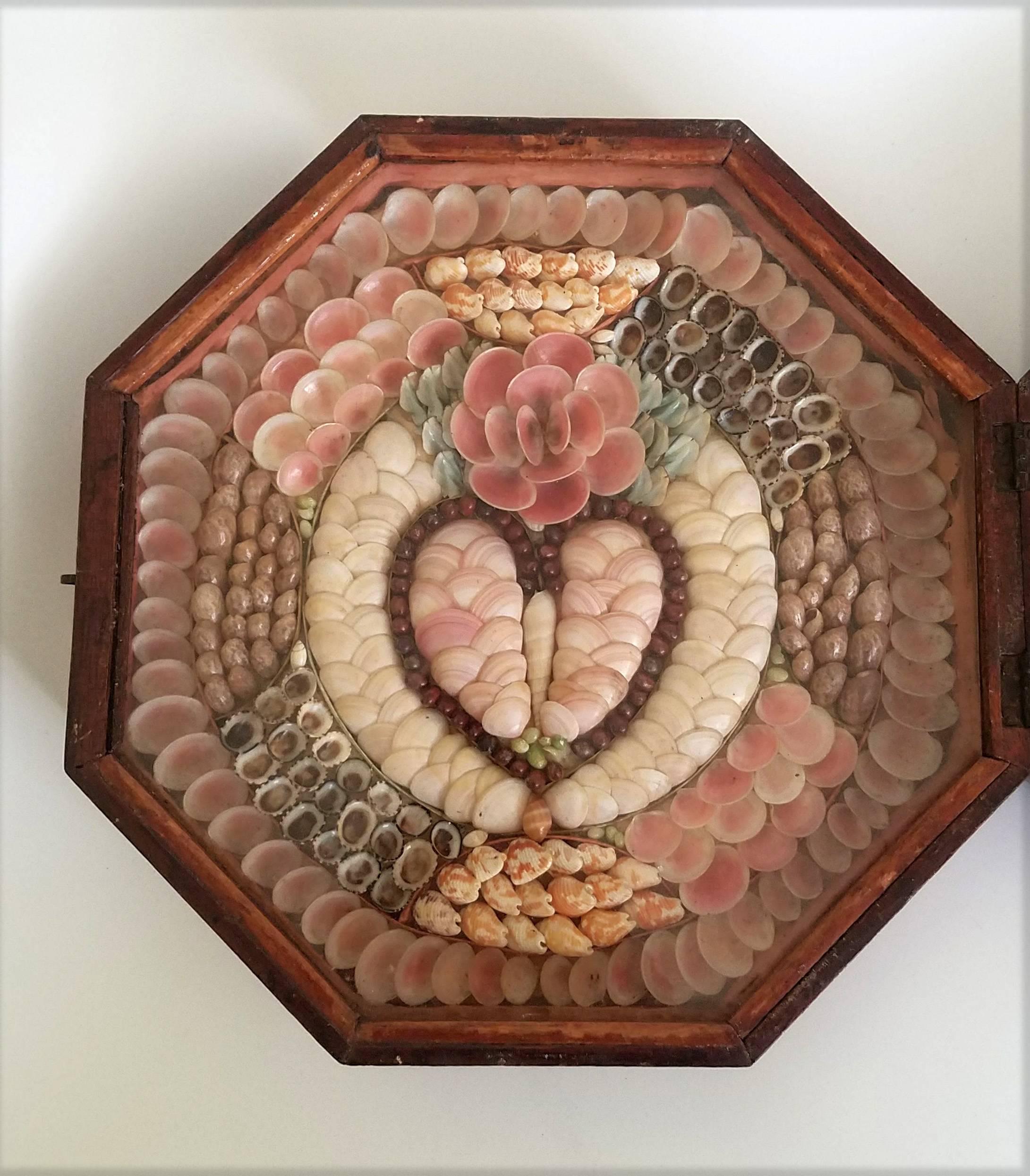 Sailor's Double Valentine, 
Barbados, 
circa 1885.

A Victorian mahogany framed boxed Sailor's Valentine, with decorative shell heart detailing to one side and with 