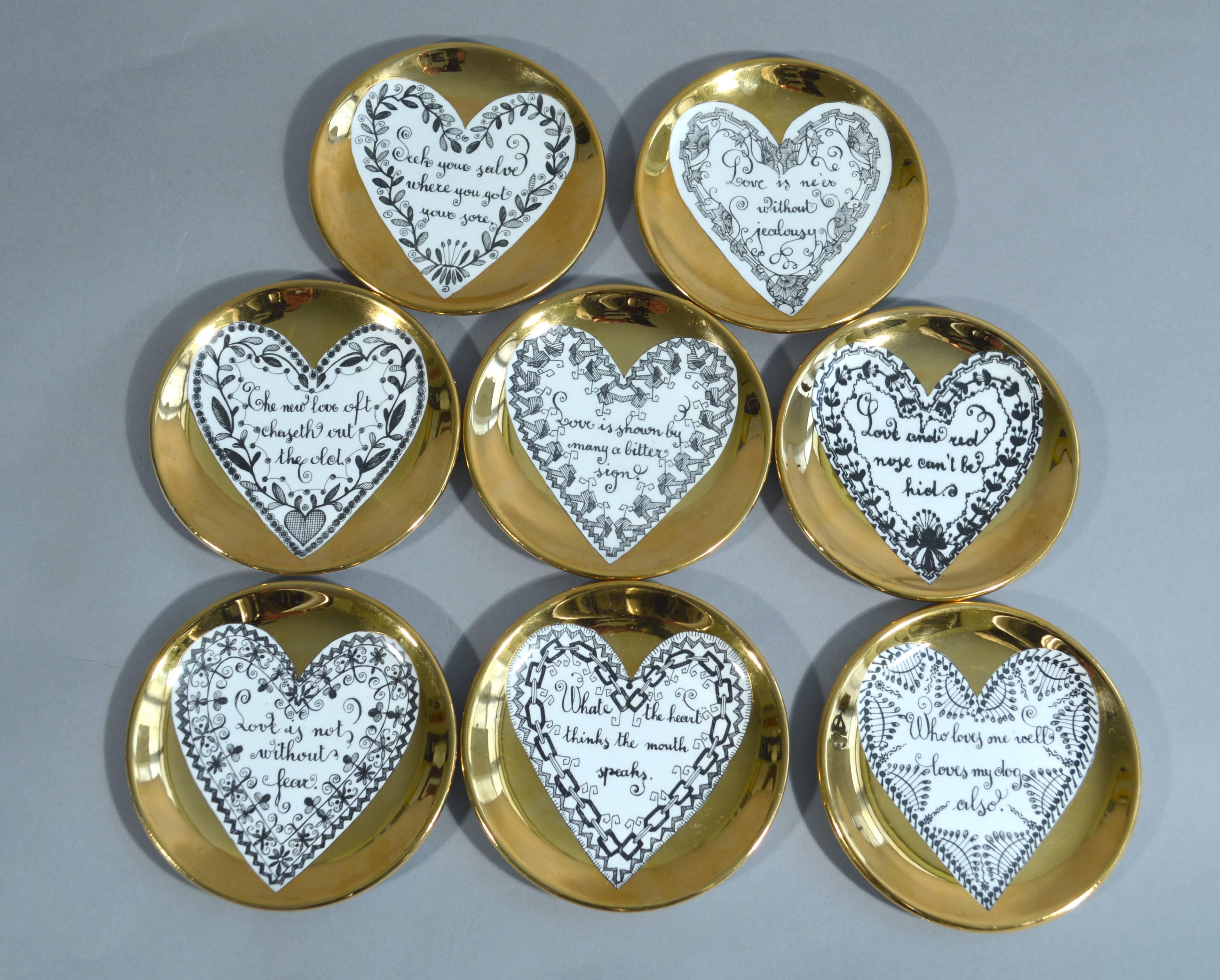 Piero Fornasetti love coasters, 
1960s.

Each coaster has a central white heart on a gold ground. Within each heart is a saying about love framed by a different heart shaped border.

The saying or proverbs read as follows

Love is not without