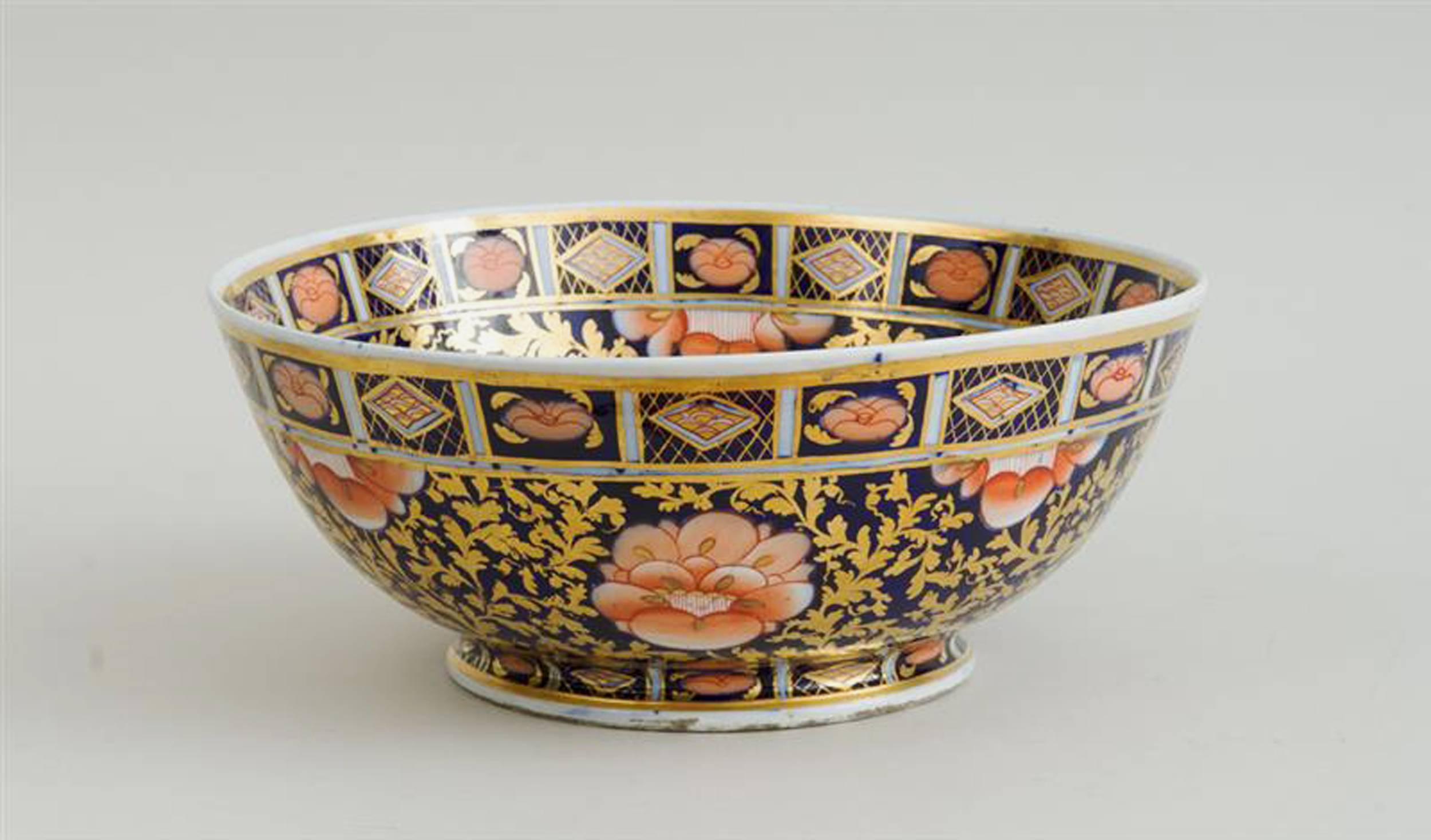 Mason's Ironstone large Imari pattern punch bowl,

circa 1820-35

The large bowl painted inside and out with an overall design in Imari colours and gold with the rim and inner center border with alternating panels of shapes on a trellis-work ground.