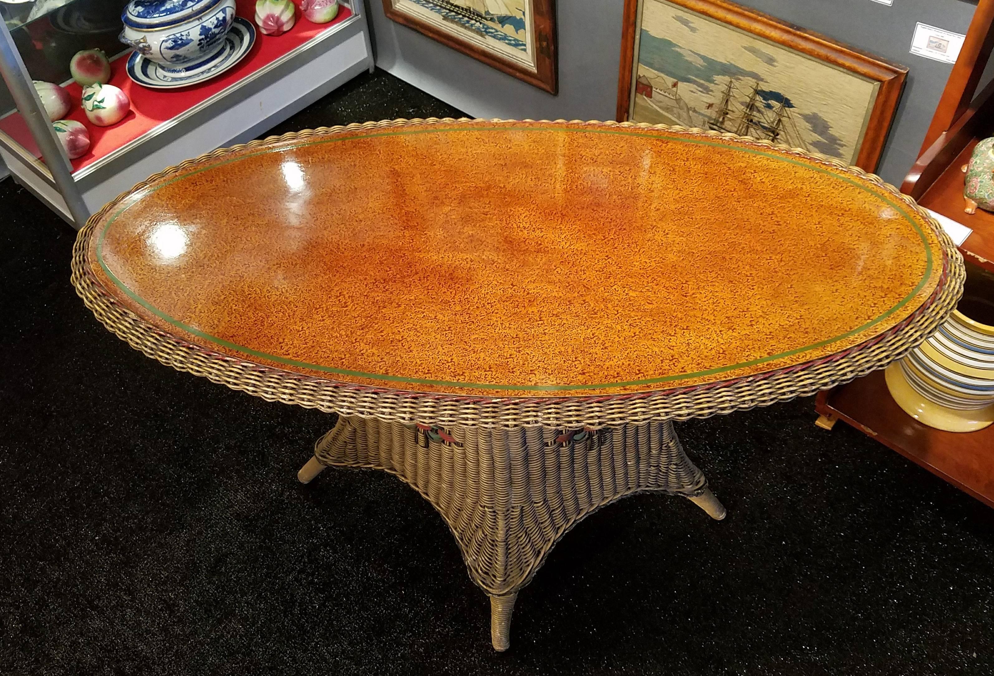 American Wicker Large Table with Grain-painted top,
By Merikord American Chair Company,
Circa 1920s.

The table has a large oval painted wood inset top inset on a wicker square base with original paint.

The table was used in Woody Allen's next